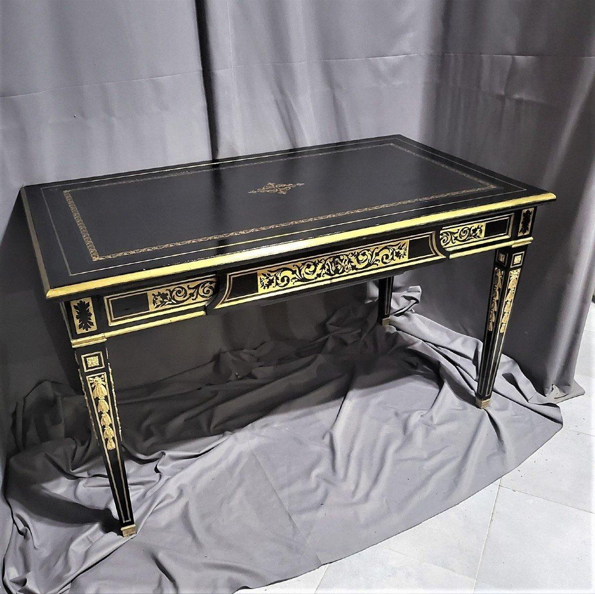 Elegant  Louis XVI style desk table from the Napoleon III period, made in brass Boulle marquetry style on a solid black dark wood veneer background. Beautiful marquetry with foliage motifs, scrolls and interlacing, all around. A belt drawer across