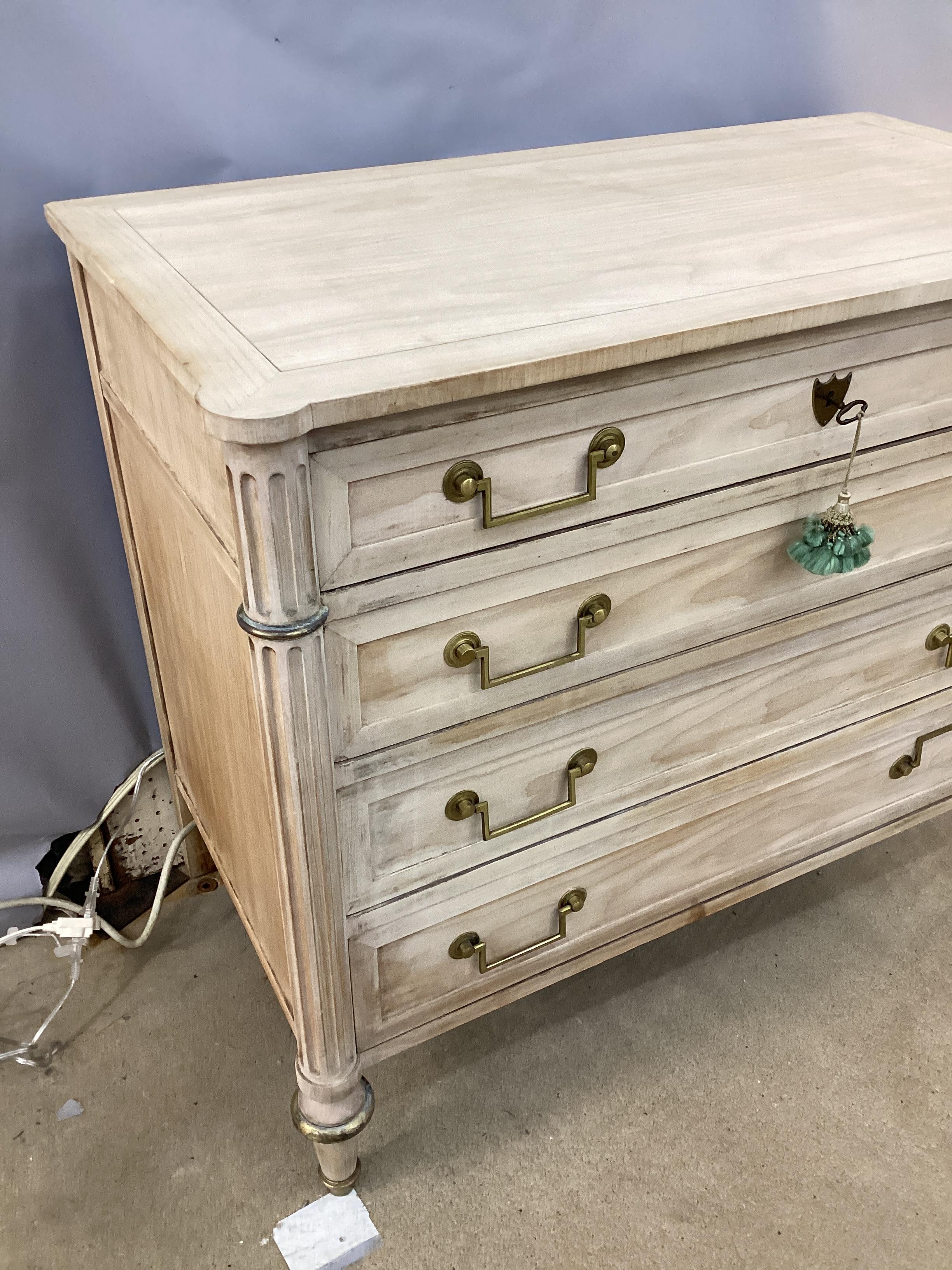 Louis XVI Style Bleached Chest by Baker Furniture Company. Brass mounted with side fluted columns. Top drawer has the original Baker Furniture Company plaque.. Retains the original key.