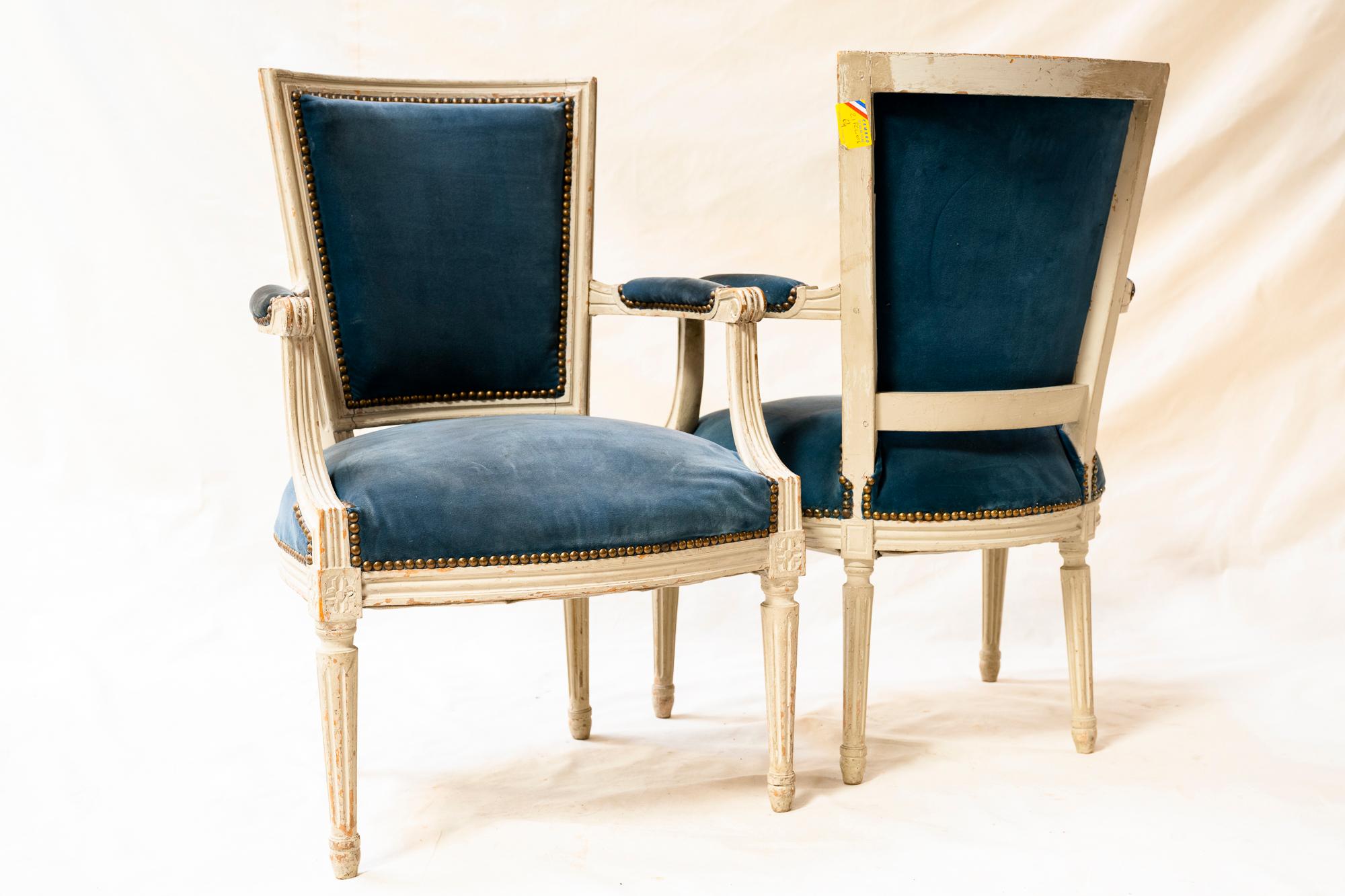 Pair of classic whitewashed Louis XVI armchairs with blue velvet, from a small chateau in the Dordogne valley. In excellent condition for their age, they may be kept as is, or refreshed with a newer fabric.