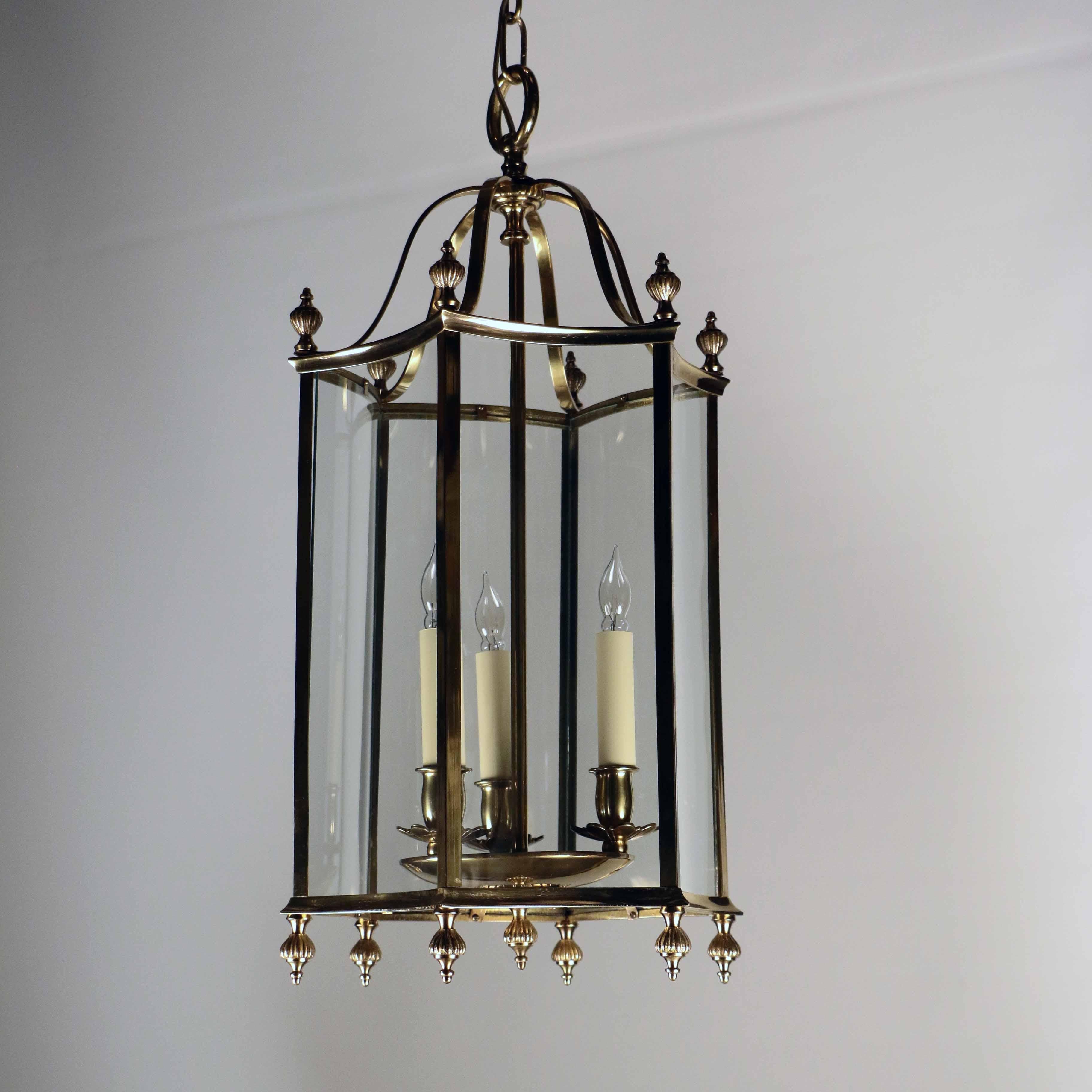 Louis XVI style brass and bent glass three-light lantern , this fixture is of a very simple and clean design but has these concave re.entrant glass panels which add an unusual look.