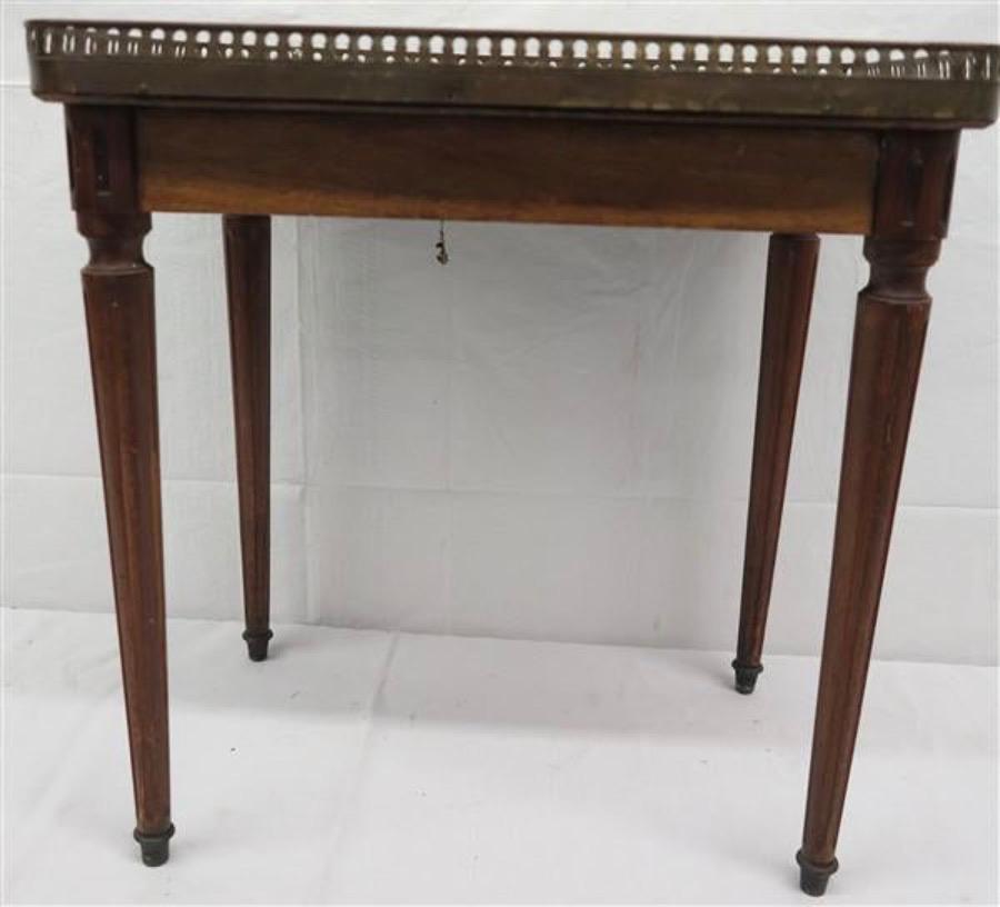 19th century, Louis XVI style mahogany side table with marble top brass gallery.