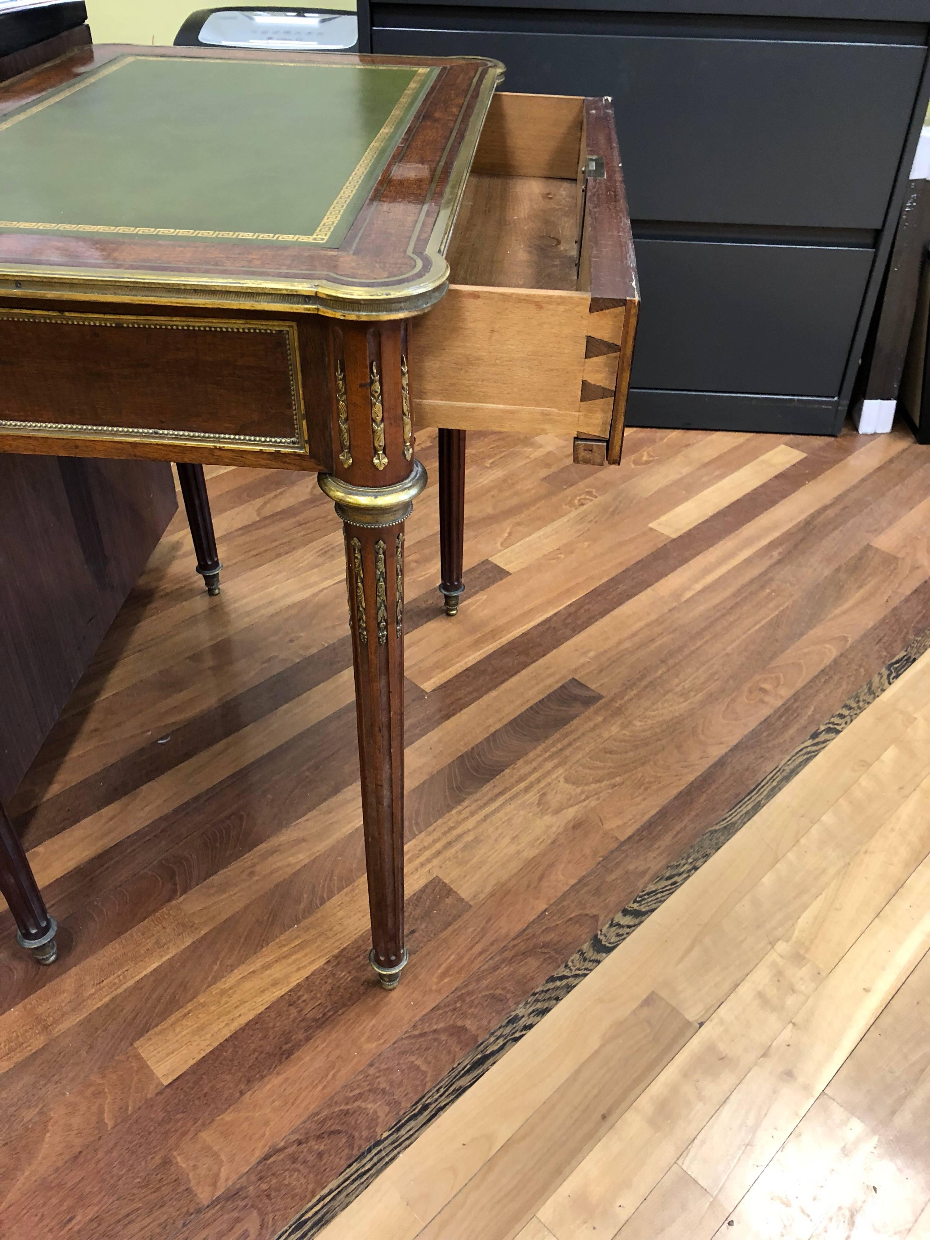 Louis XVI brass inlaid mahogany desk with parcel-gilt and green leather inset top. The mahogany veneered on oak.
With a single drawer. Lock not working.