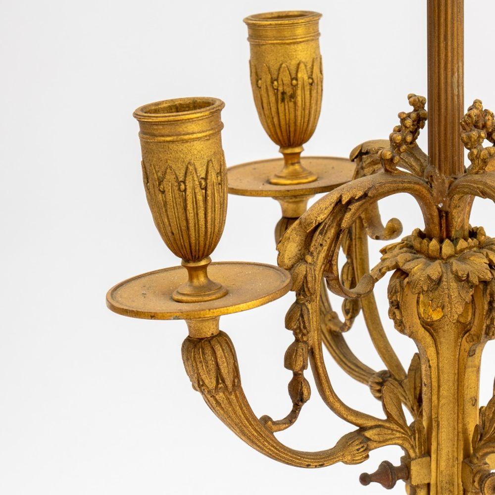 Louis XVI Style Gilt Bronze Candelabra Mounted as a Lamp, late 19th century, four branch candle mounts, two light fixtures, with acanthus leaves and draping garlands, oval base with clouds mounted on toupie and goats feet. 22.5