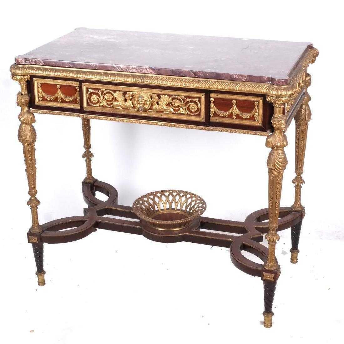 Louis XVI style bronze center table desk in the manner of Adam Weisweiler with marble,
early 20th century

Having a rectangular red marble top in a bronze frame, above a wide apron having a single drawer centered by bronze mounts depicting a mask