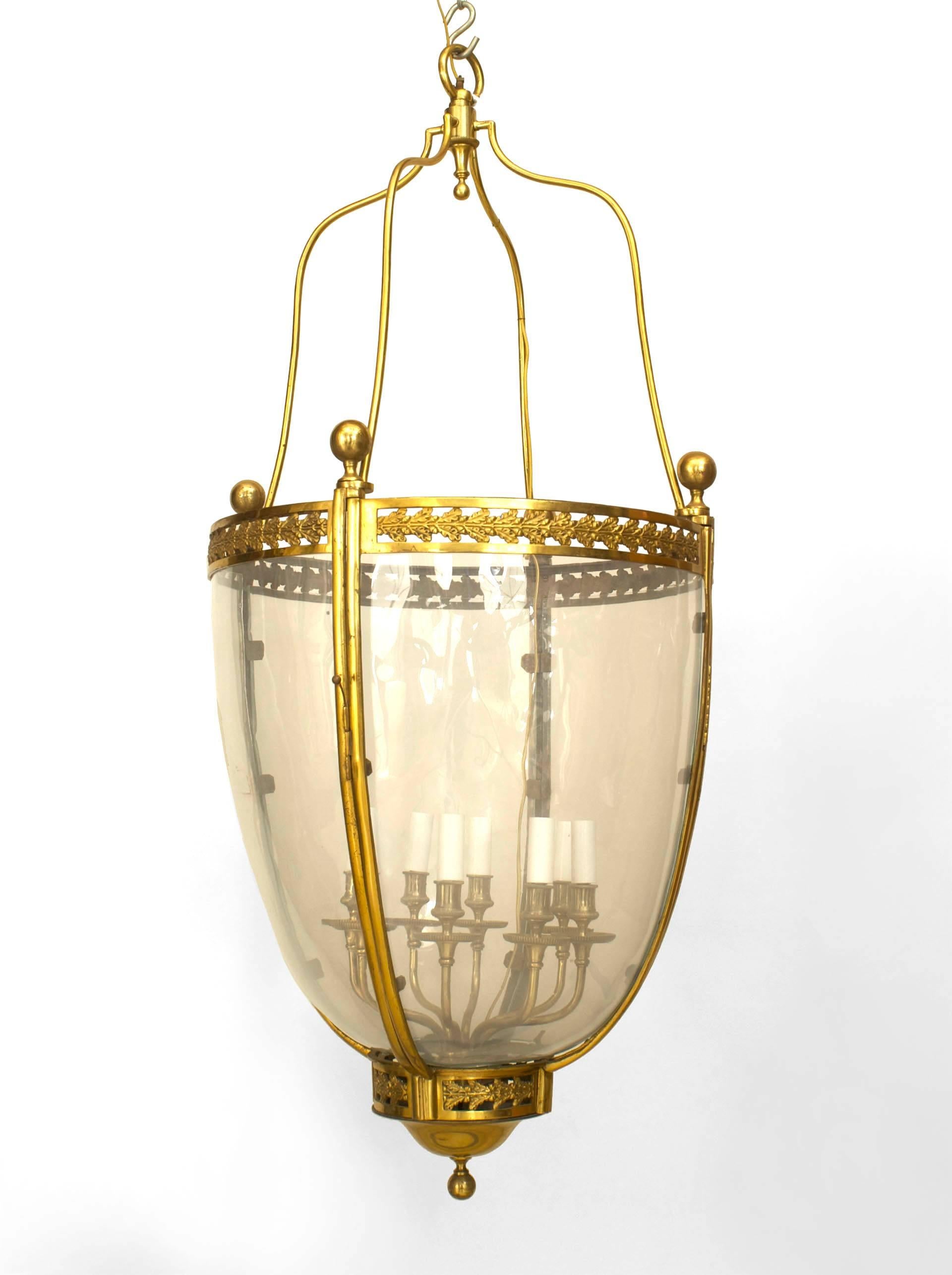 French Louis XVI style (20th Century) bronze dore round tapered shaped hanging lantern with 4 glass panels and 8 arms.
