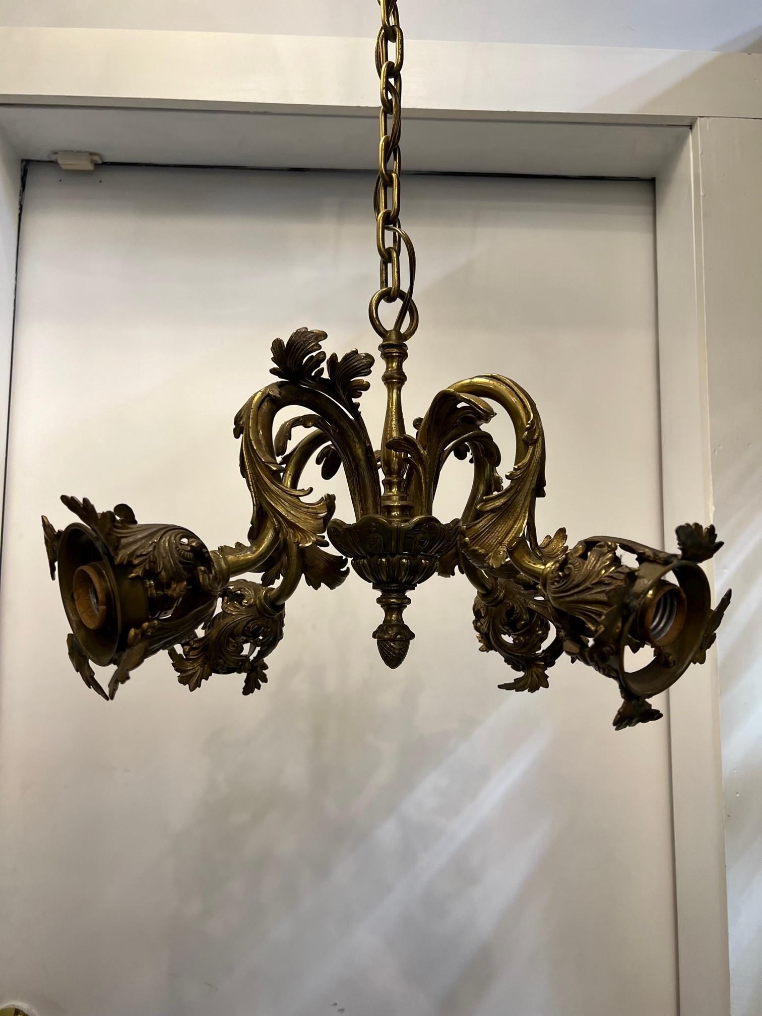A small but very nice French Louis XVI style chandelier. Four decorative bronze branches each with sockets all in working condition. I do not have the glass shades, originaly it had four art glass shades which you can replace with reproduction glass
