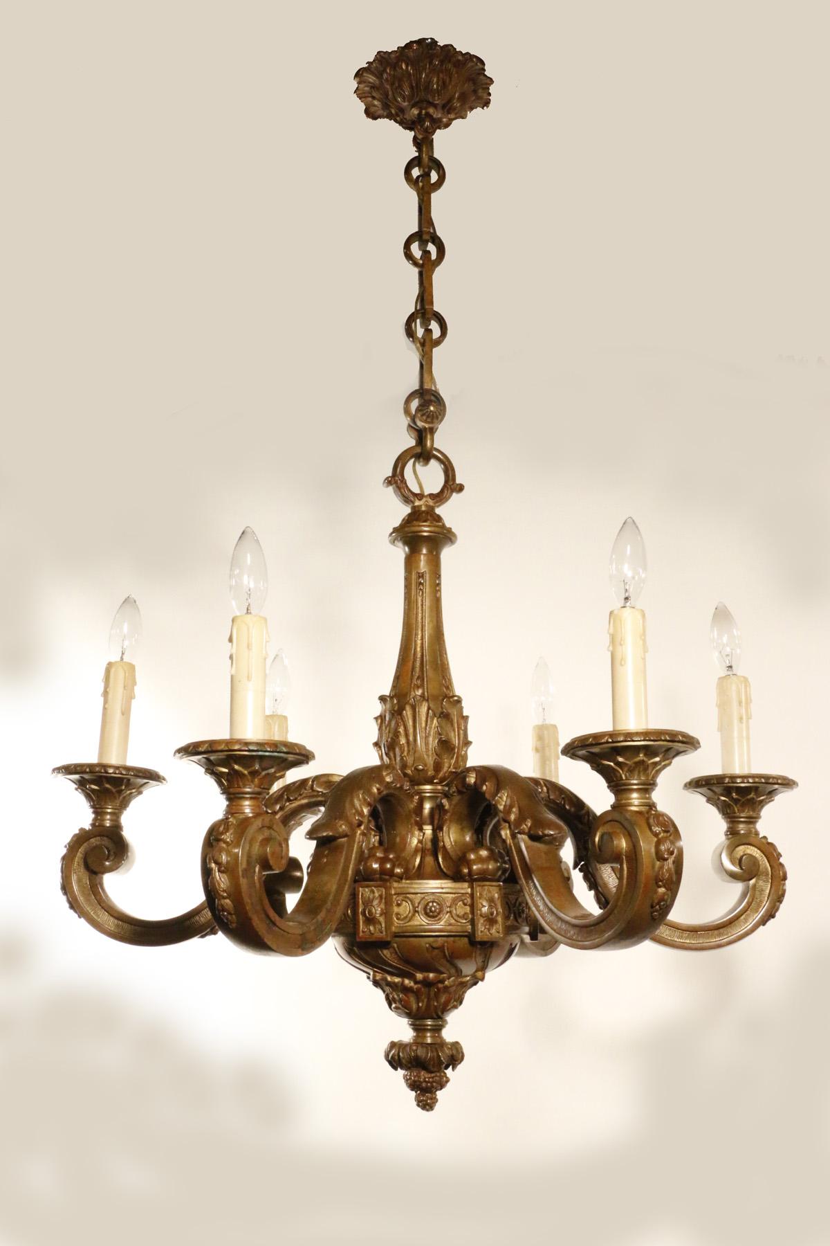 This high-quality chandelier is well modelled and crisply cast. The arms are applied with stylized acanthus, as is the fluted tapering stem. The lower finial is decorated with acuthus leaf and clusters of grapes.