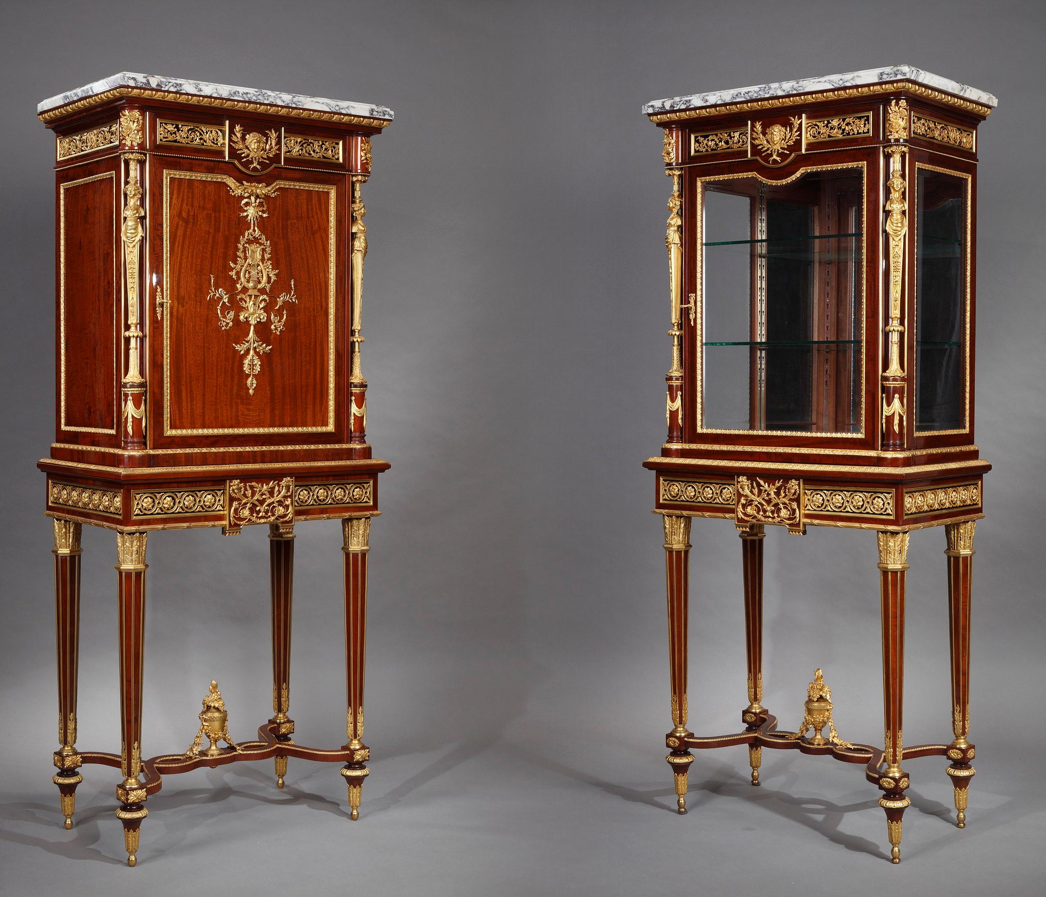 Exceptional Louis XVI style cabinet and its companion vitrine beautifully mounted with chiseled and gilded bronze. They are surmounted by a rectangular top with an egg-and-dart molded edge, above a frieze centered by a laurel-festooned Bacchic mask