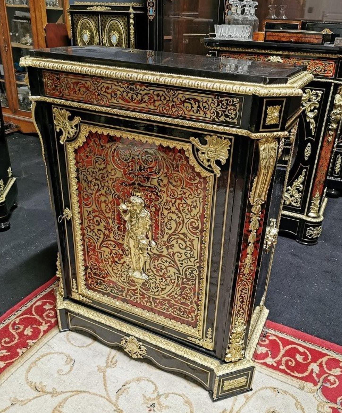 Gorgeous Louis XVI style cabinet in Boulle style marquetry in blackened pearwood, with a rich full brass door and tortoiseshell marquetry, composed of scrolls, interlacing and foliage. Important ornamentation of gilded bronzes with high and low