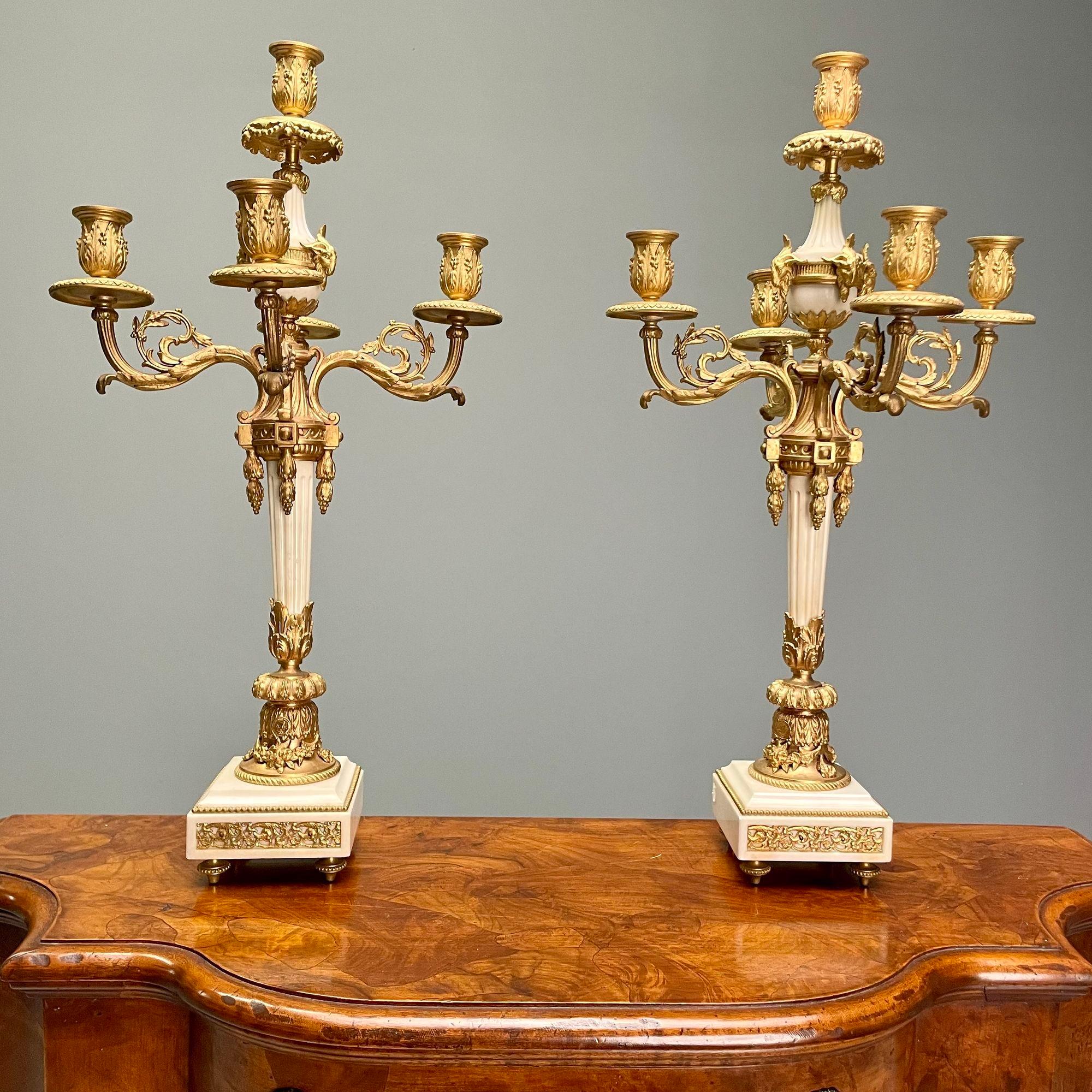Louis XVI Style, Pair of Candelabras, Gilt Bronze, Marble, France, 1920s

Pair of candelabras having rams heads with five arms are large and impressive flanking a mantle clock displaying the lovely Leto playing in the garden with between two marble