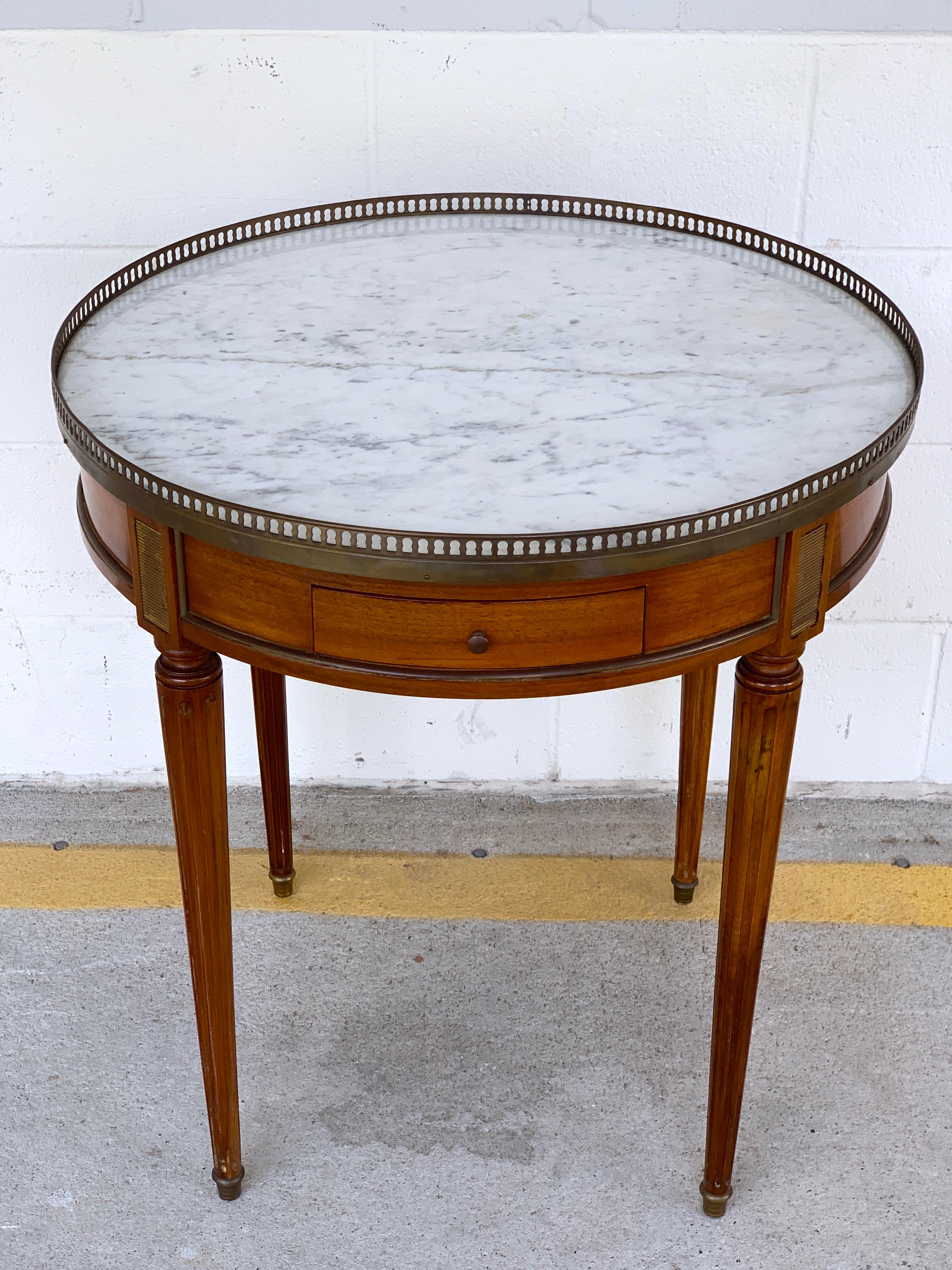 Louis XVI style Carrara marble-top Bouillotte table, stamped made in France
With pierced brass gallery, with 8.5