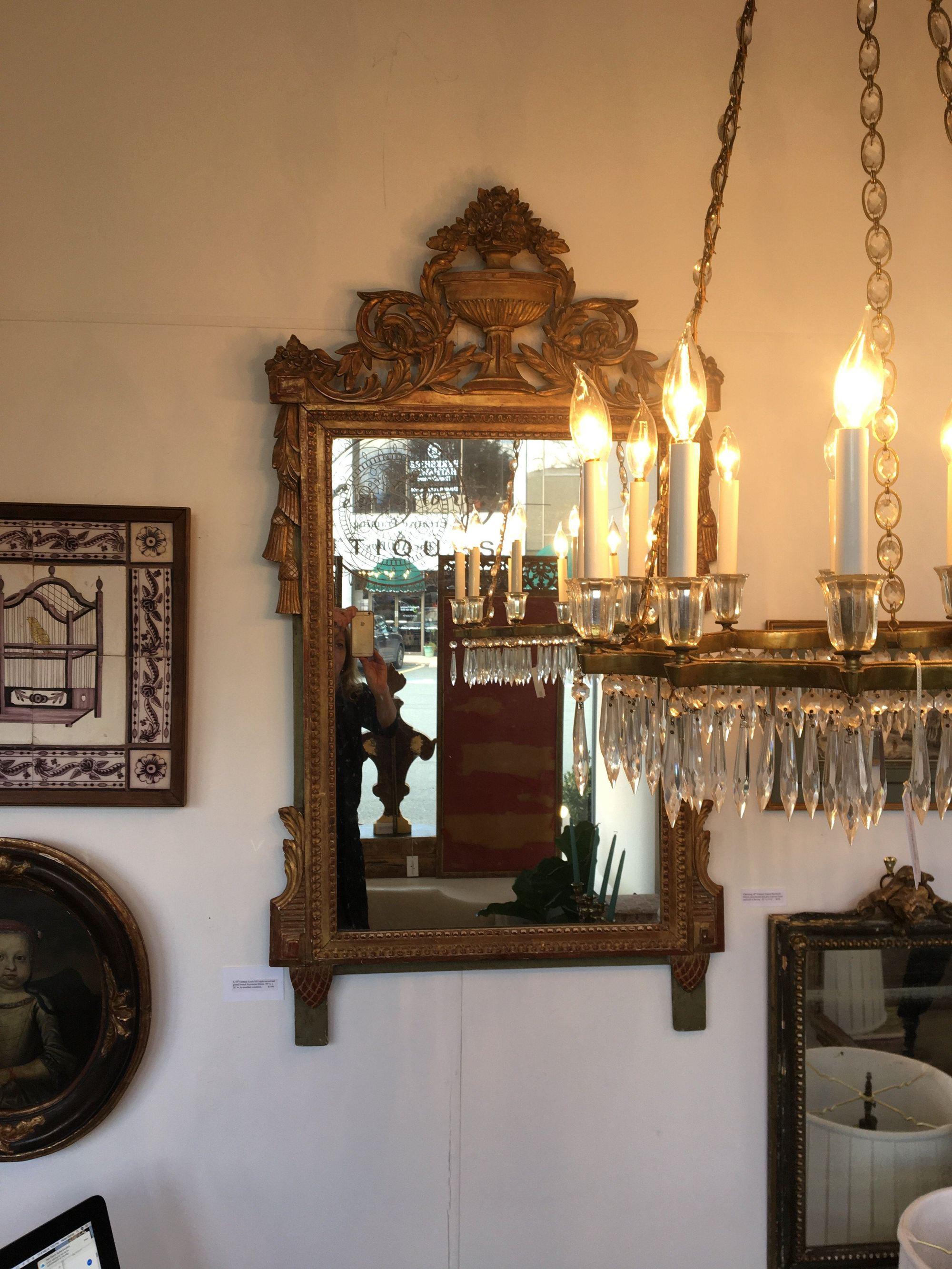 A 19th century Louis XVI style carved and gilded French Provincial mirror, 50” H. x 20” W. In excellent condition.
