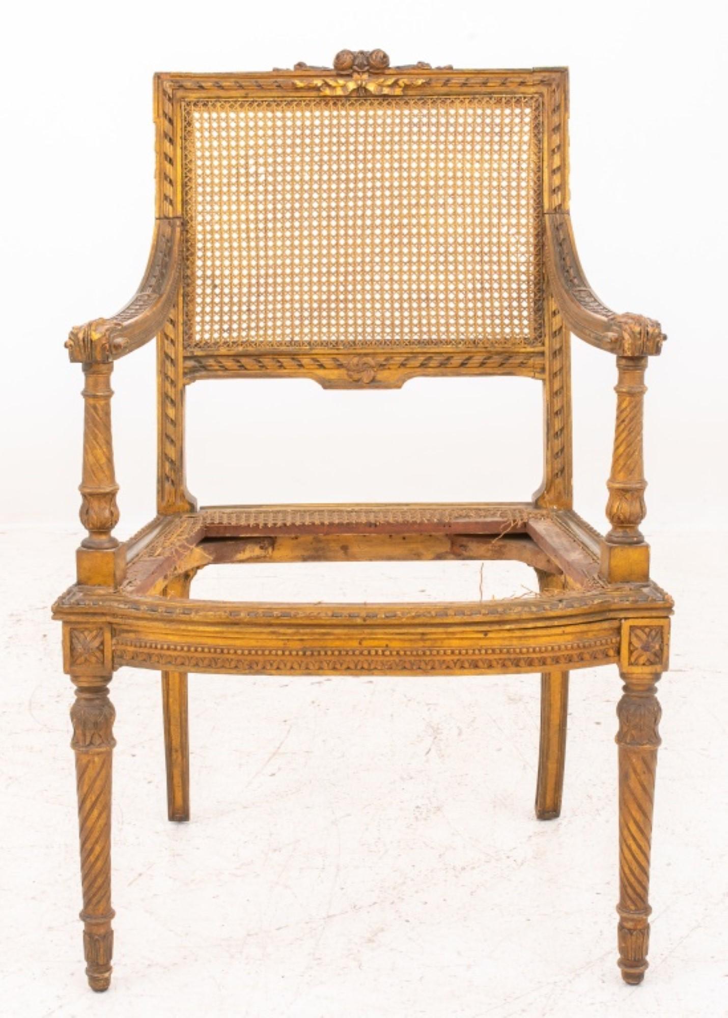 Louis XVI style carved giltwood armchair  raised on turned tapered legs, back and seat  caned, seat caning in distress condition,  circa late nineteenth century. 

Dealer: S138XX