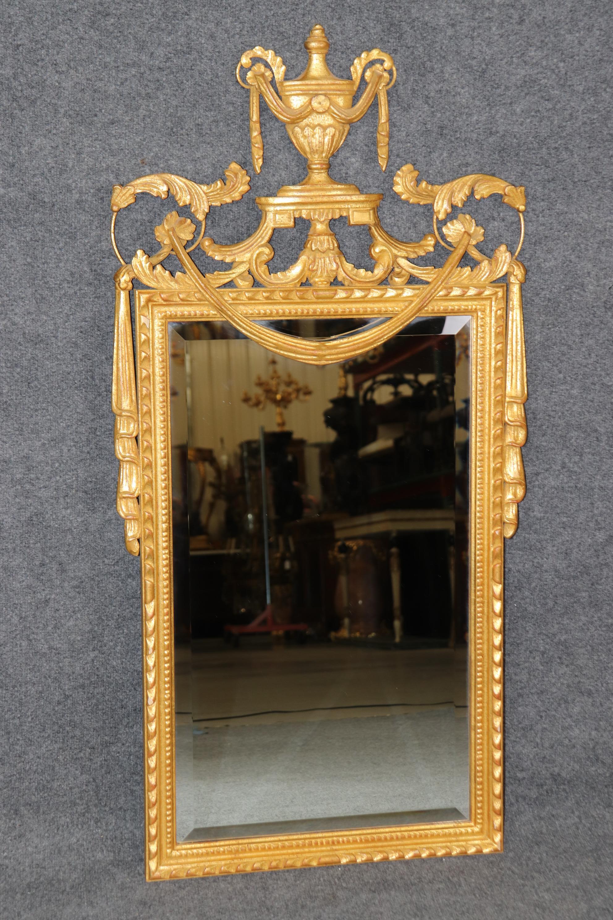 Dimensions - H: 47 in W: 23 1/2 in D: 1 1/2 in 

This Louis XVI Style Gold Carved Gilt Mirror, signed by the renowned maker LaBarge and crafted in Italy, is an exquisite piece that brings the timeless elegance of French neoclassical design to life