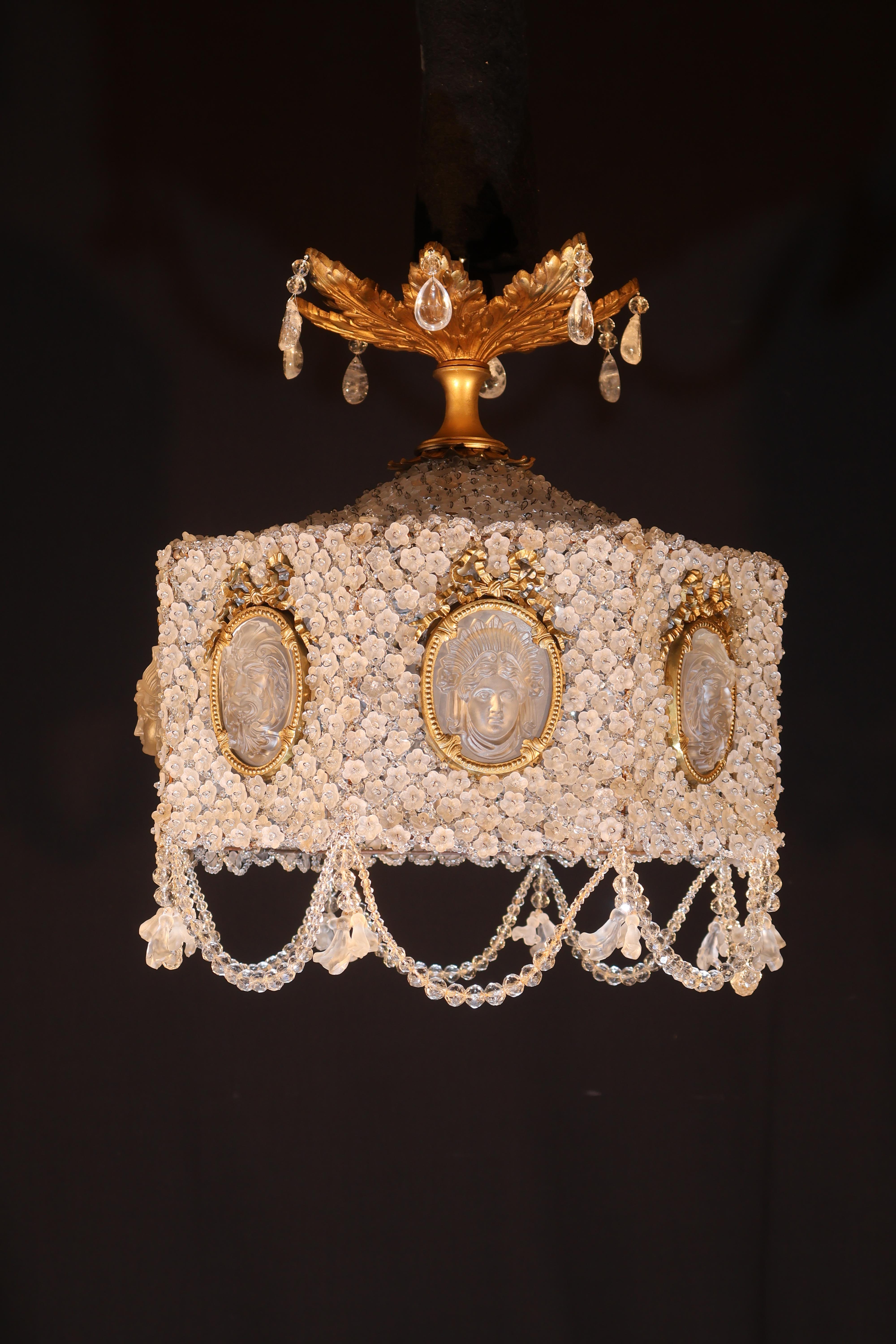 The Octagonal Shaped Body Ornated with Frosted Glass Flowers Centered by a Bead, Oval Inserts Depicting Lalique Medallions. Beaded Garlands. 
France, circa 1920. 
Dimensions: Height 21