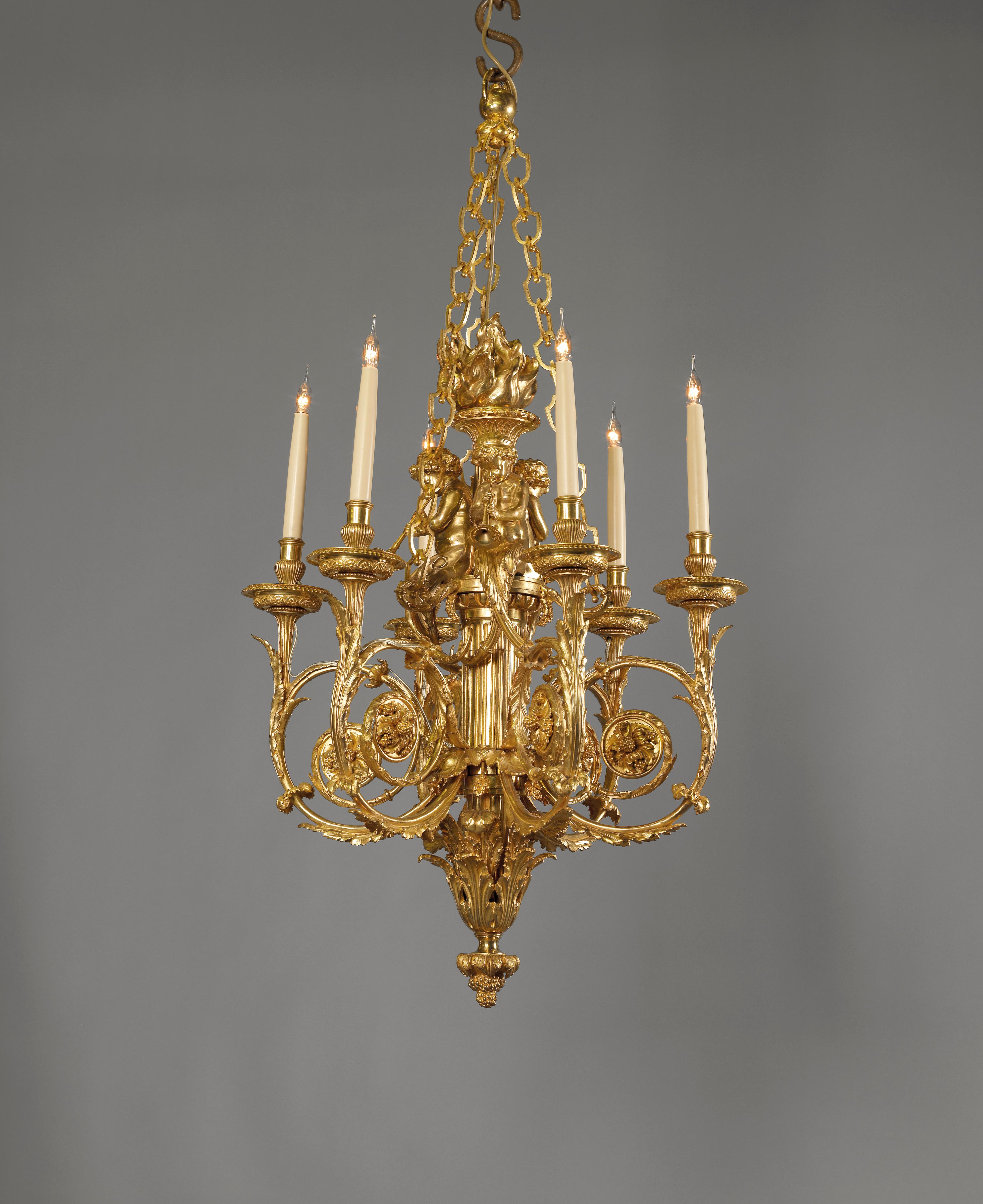 A fine Louis XVI style gilt bronze cherub six-light chandelier, after the model by Pierre Gouthière for Marie Antoinette. The chandelier having elaborate acanthus scrolling arms issued from a classical torch stem surmounted by three perching
