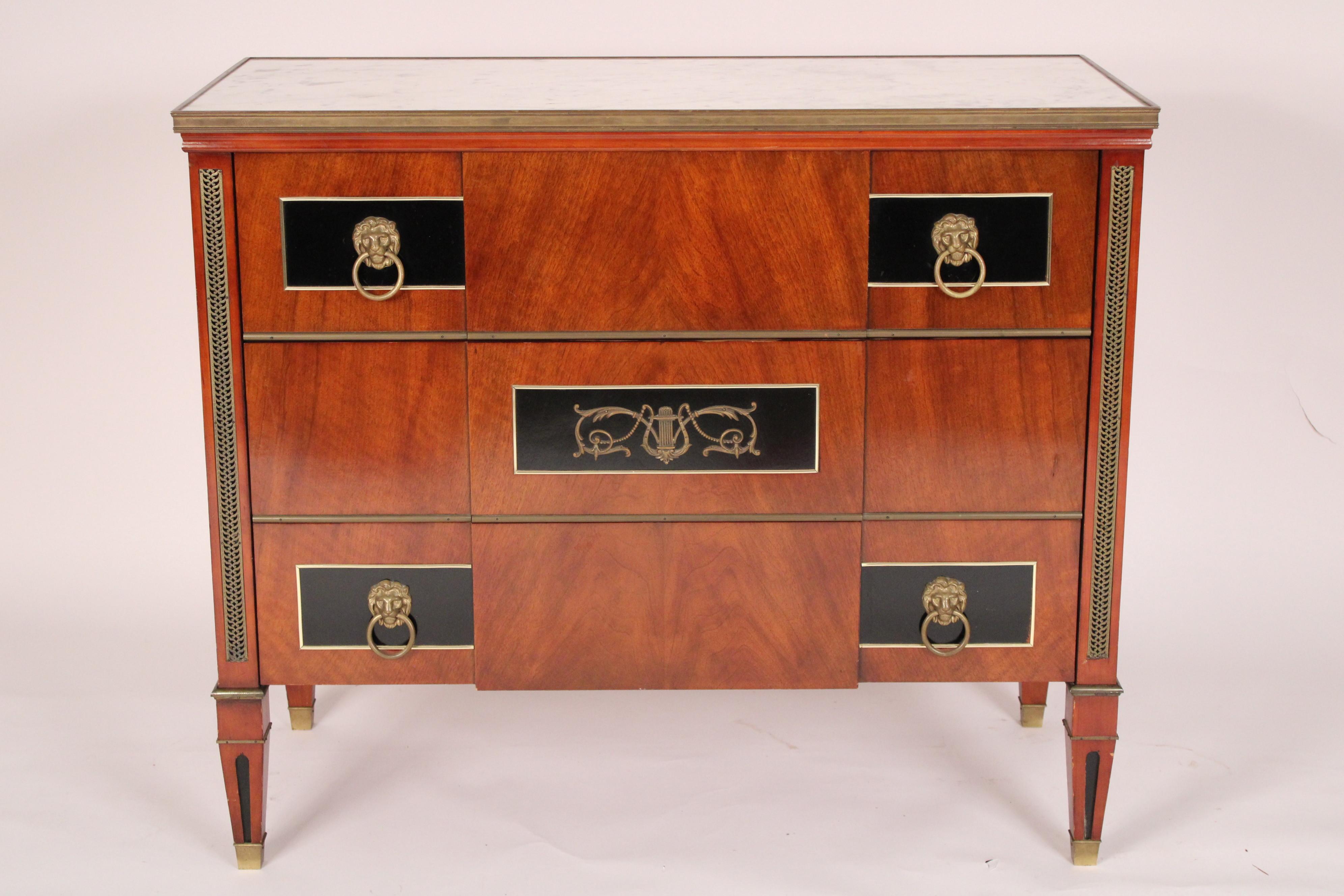 Russian or Swedish style Louis XVI mahogany, lacquer and brass chest of drawers, circa 1980's. With a rectangular carrera marble top with brass banding, 3 drawers the top and bottom drawers with black lacquered panels with brass lion head pulls, the