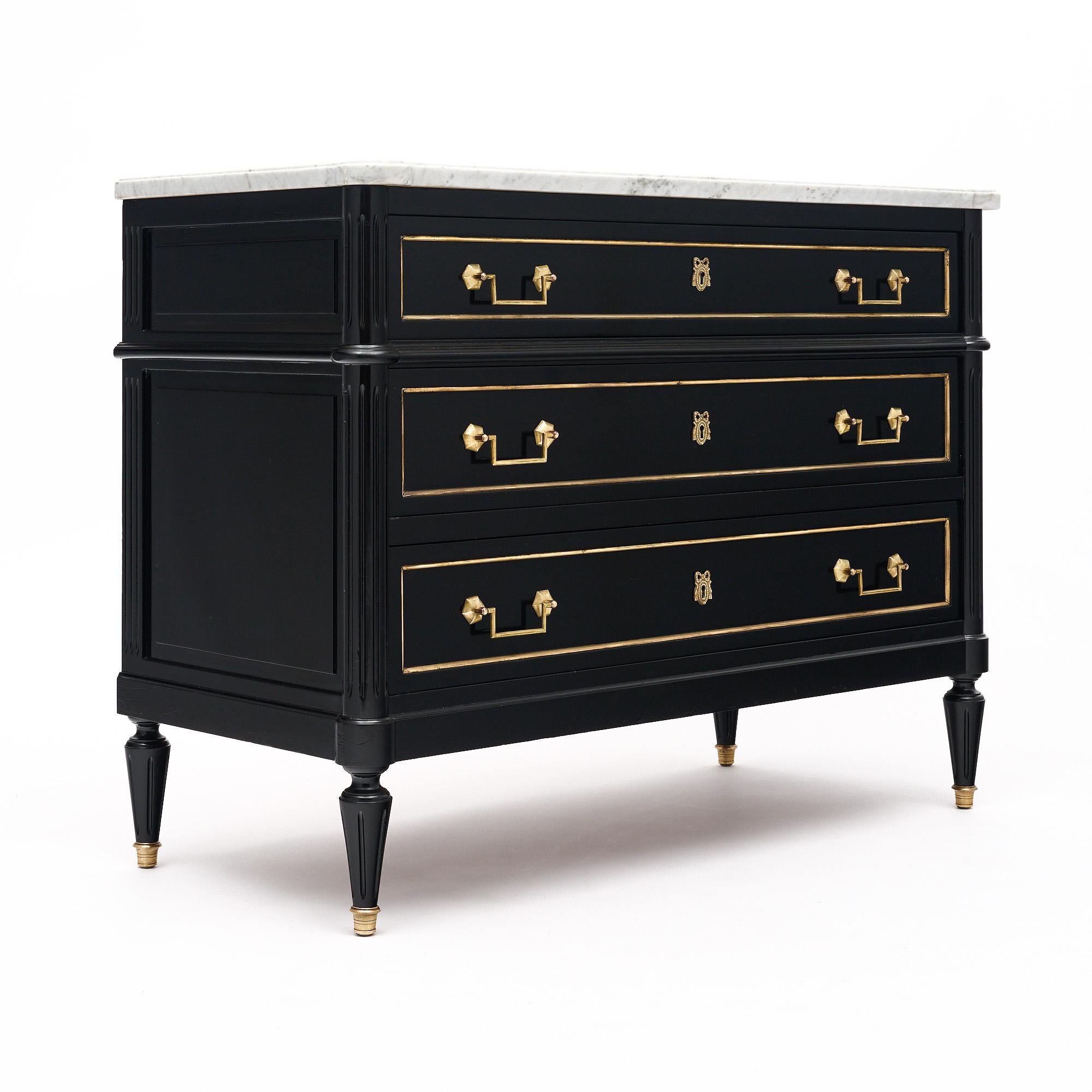 Chest of drawers from France in the Louis XVI style. This piece is made of mahogany that has been fully ebonized and finished with a lustrous French polish of museum-quality. There are three dovetailed drawers all featuring cast brass trim and