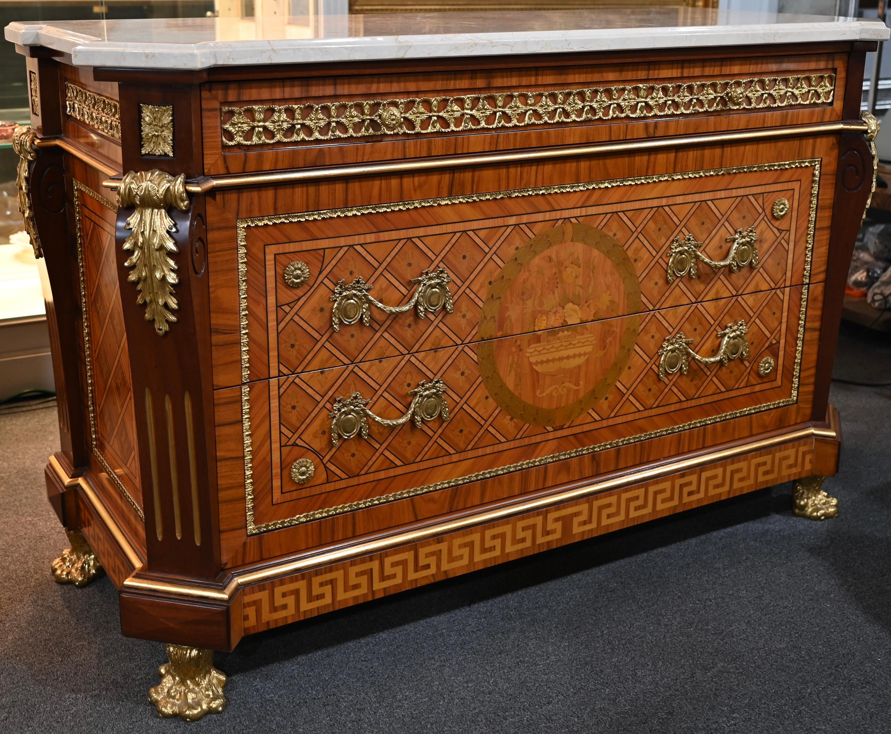 A very fine quality Louis XVI Style ormolu-mounted commode or chest of drawers with an Italian white marble top that is truly breathtaking! Intricate inlaid marquetry design throughout, the front and sides of the piece as well. Remarkable attention