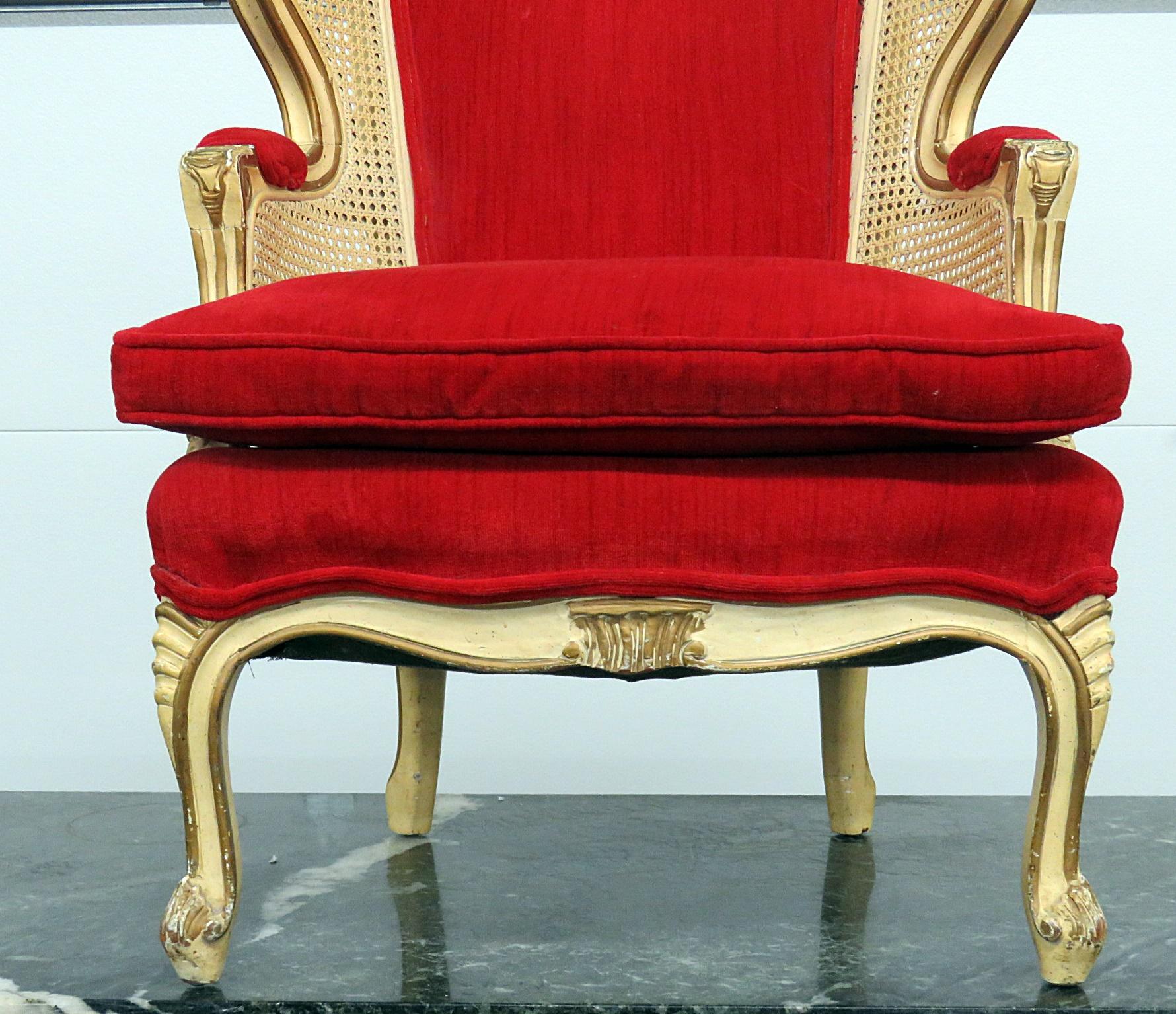 Louis XVI style child's wingback chair with cane sides.