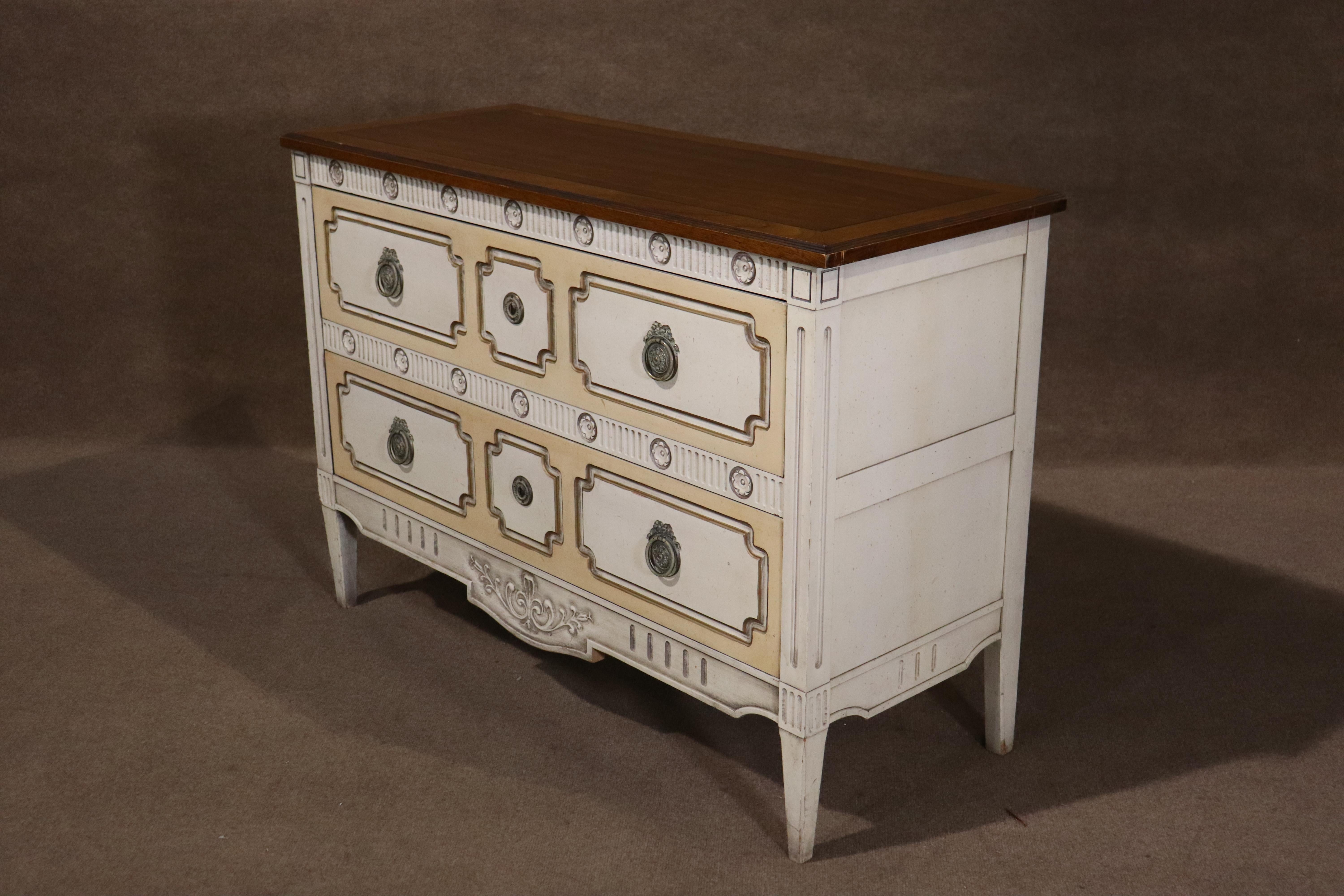 This two drawer commode by Drexel features great antique details such as brass ring hardware, and scrolling details. Louis XVI style distressed paint decorated commode chest of drawers is made of the highest quality, and gives attractive storage for