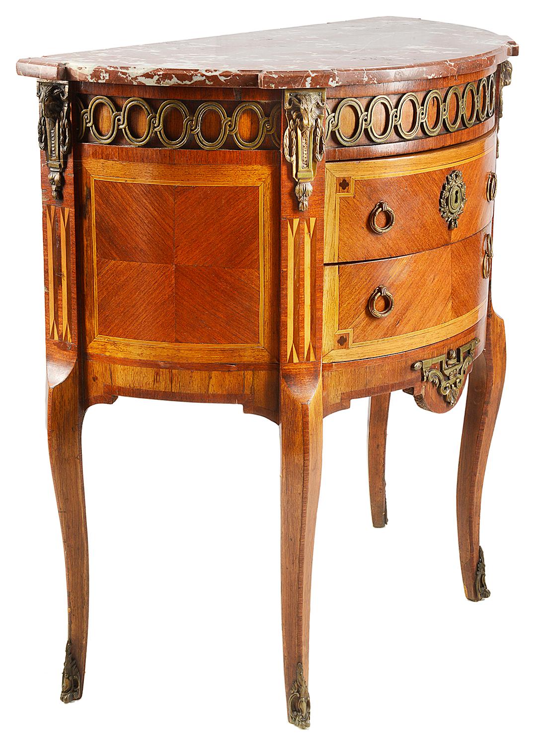 A good quality early 20th century Louis XVI style French commode. Having its original rouge colored marble top, ormolu mounts to the frieze and apron. Two bow fronted drawers each with boxwood inlaid decoration to the crossbanding, raised on elegant