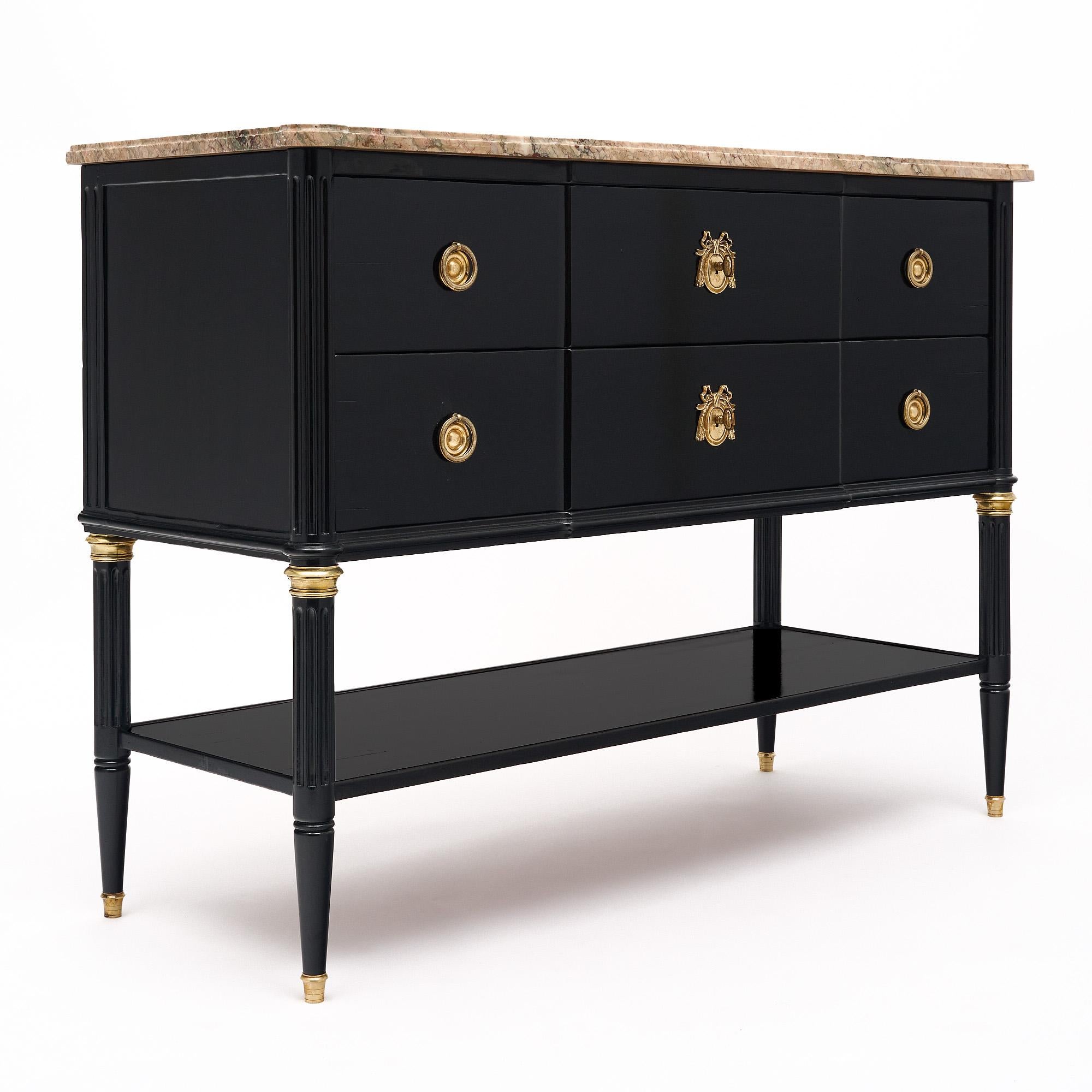 Chest or console case piece from France in the Louis XVI style. This piece has been ebonized and finished with a lustrous French polish finish. There are two dovetailed drawers running the length of the piece above a lower shelf. The chest is