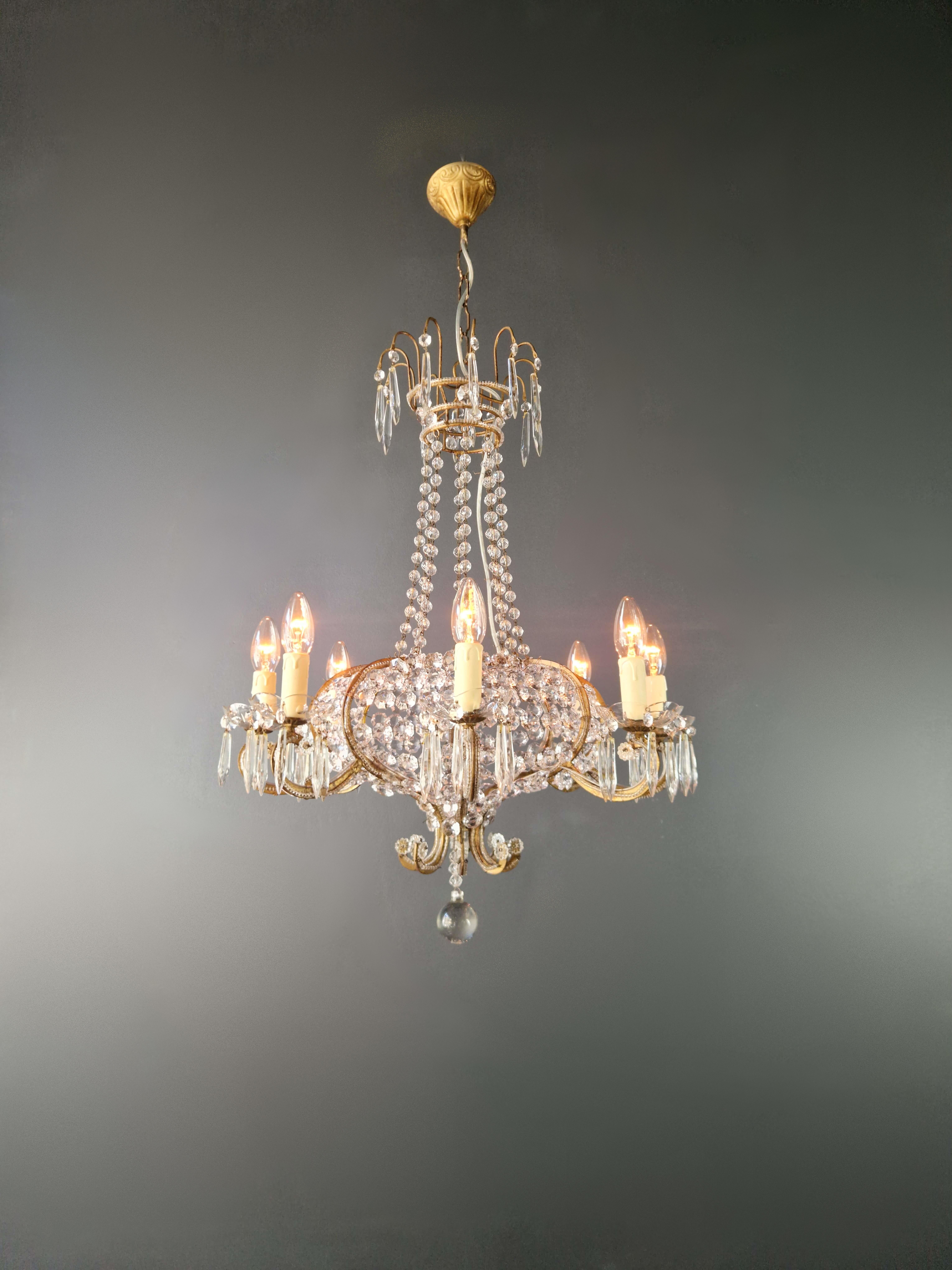 Introducing our exquisite antique crystal chandelier, a masterpiece that embodies the elegance of France.

With a height of 74 cm and a diameter of 60 cm, this chandelier exudes timeless charm. It weighs approximately 6kg and has 8 E14 bulb holders