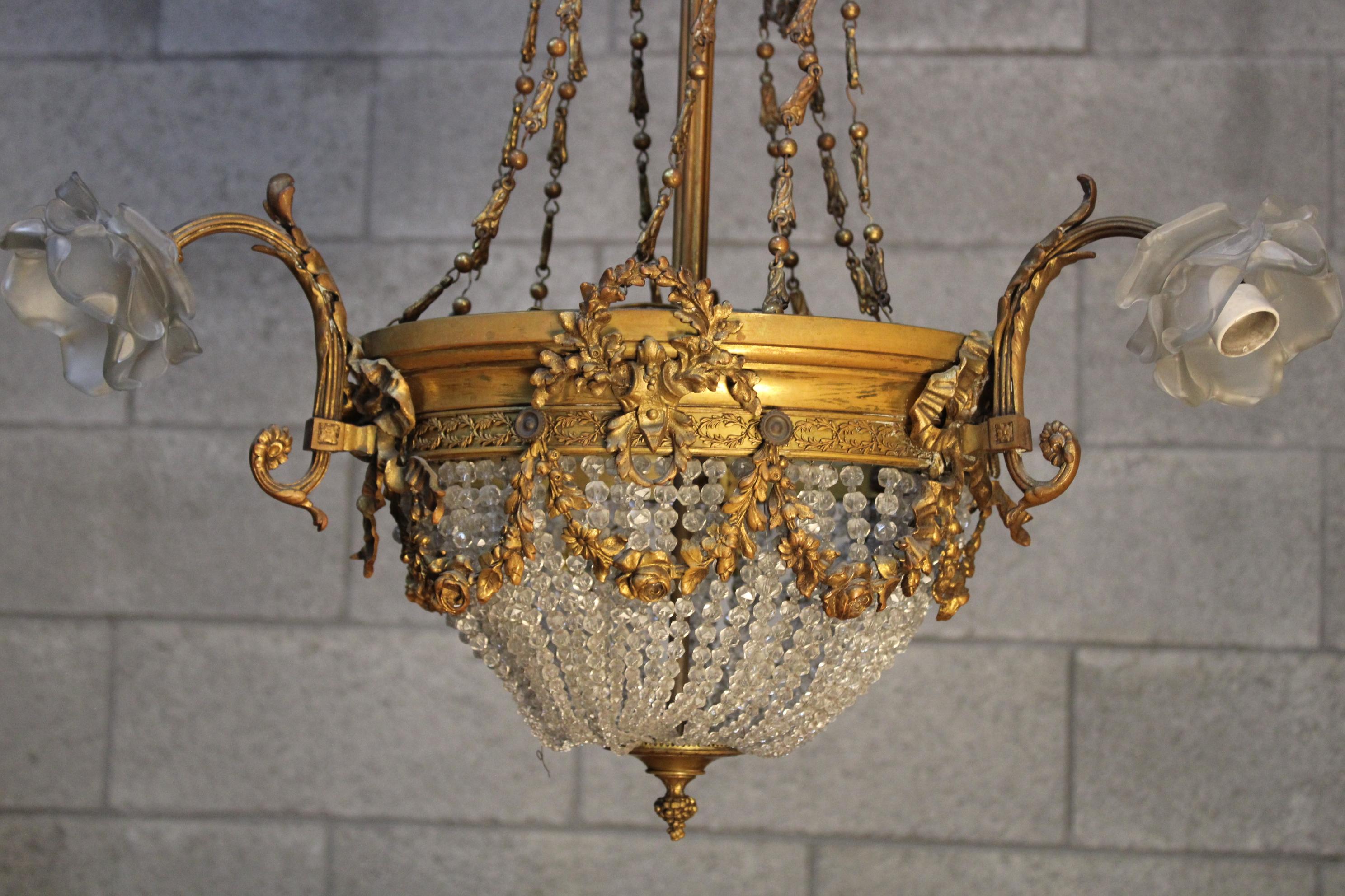 Louis XVI Style Crystal and gilt bronze chandelier from end of 19th century - circa 1860-1870 France... richly gilded and carved bronze, surrounded with crystals and 3 lights... particular piece 
Will be shipped inside a wood secured crate or will