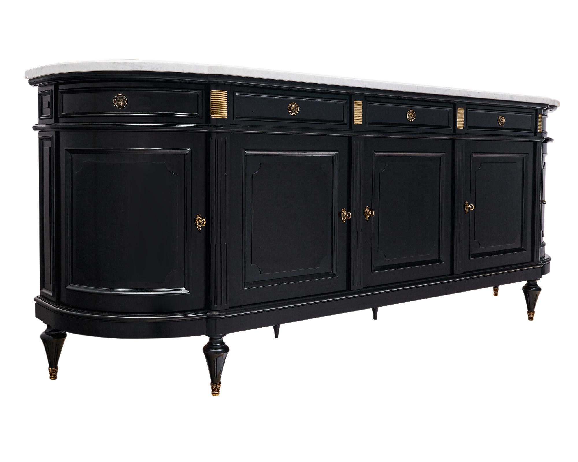 Buffet or enfilade from France made of a solid mahogany that has been finished in a museum-quality French polish for a lustrous effect. There are five doors that open to adjustable interior shelving and three dovetailed drawers. The ends have curved