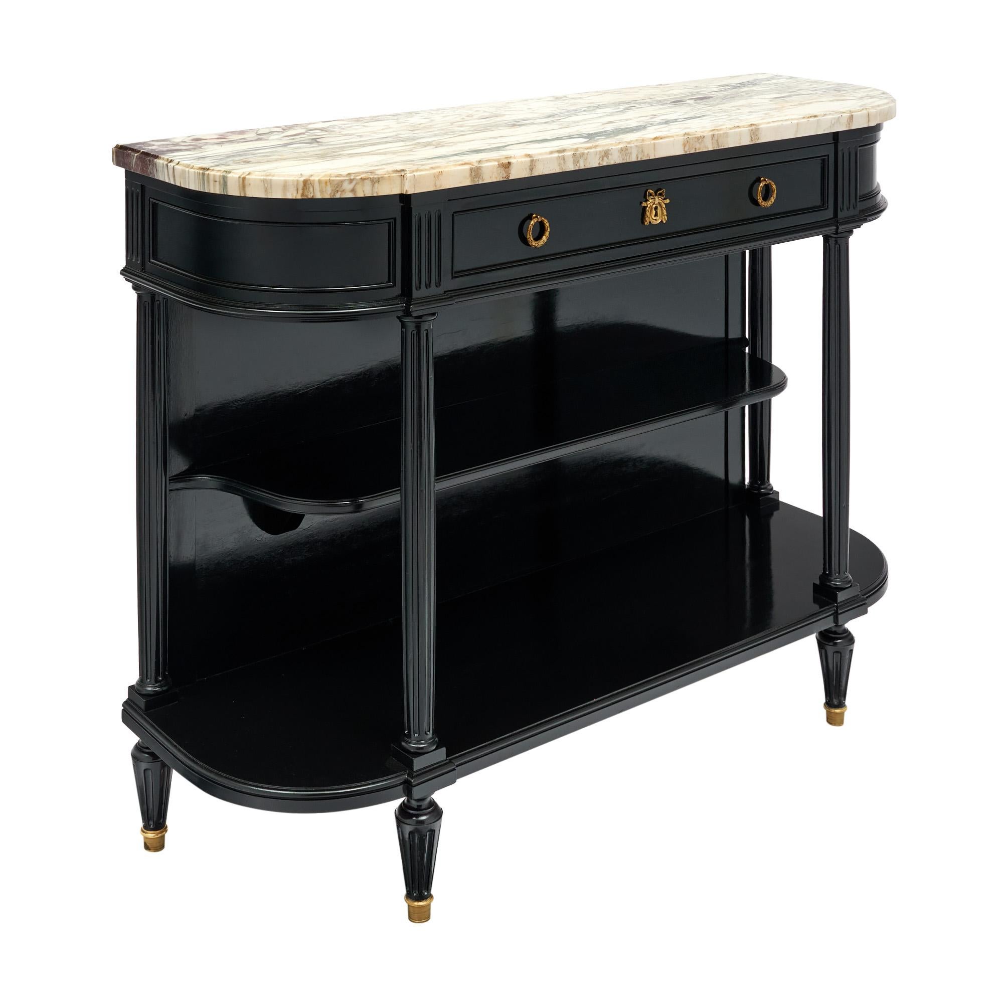 Buffet from France in the Louis XVI style. This piece is made of solid wood construction that has been ebonized and finished with a lustrous French polish of museum quality in the Napoleon III fashion. The demilune shape is a classic French detail.