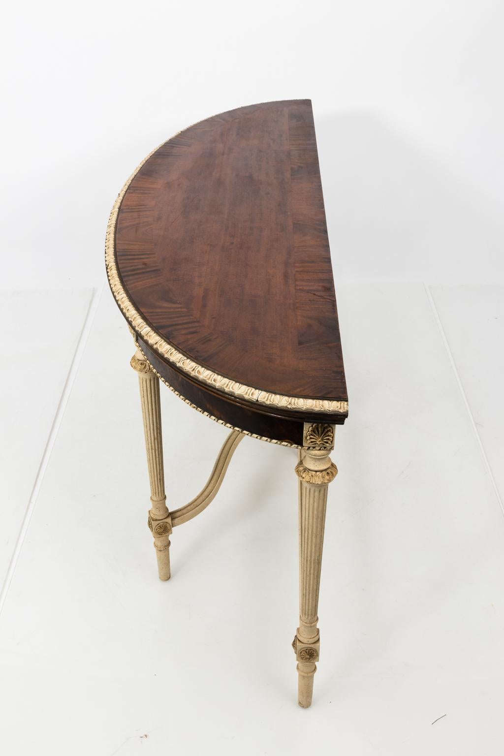 Louis XVI style painted demilune table with two drawers and a walnut top, circa 1930s-1940s. The table also features carved palmettes on the skirt with turned legs.