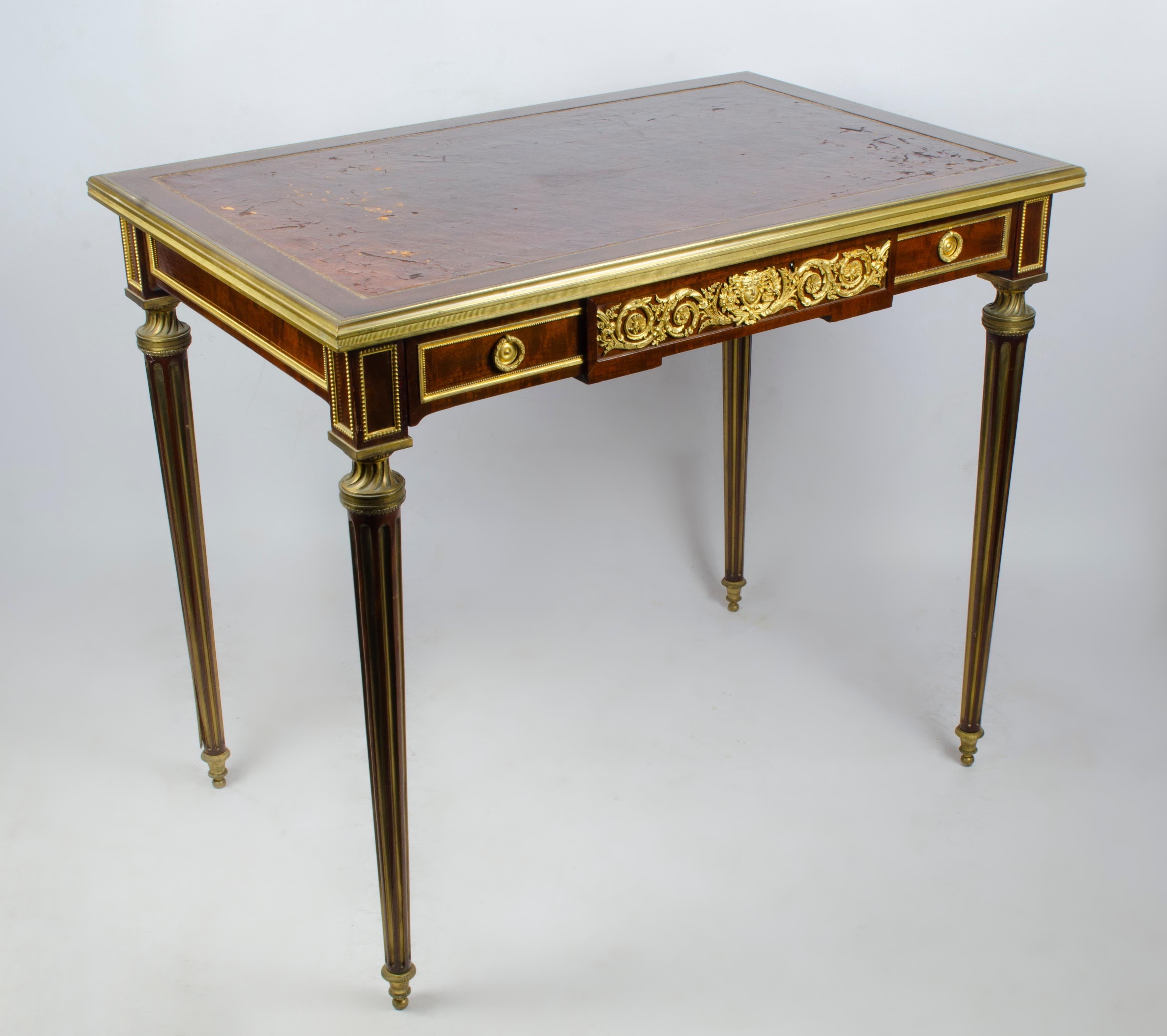 Elegant Louis XVI style desk made by Paul Sormani (1817-1877). Made of veneered wood and gilt bronze sheathed on top of a patiné havane leather. Molded and decorated on all sides with rich gilt bronze ornamentation, it contains a large drawer