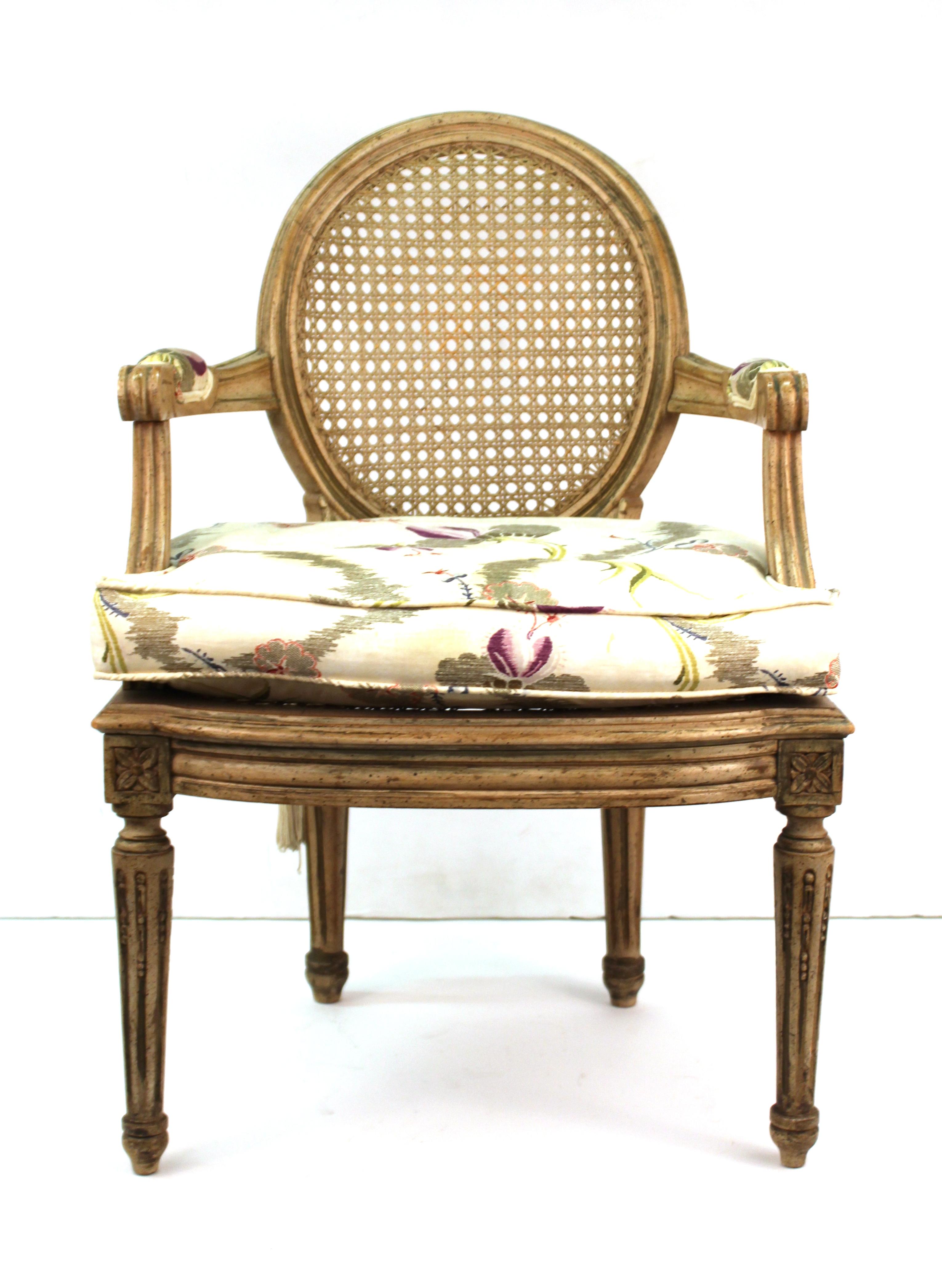 Louis XVI style diminutive armchair with caned back and seat. The piece comes with an upholstered cushion and is ideally sized for children or dolls. In great vintage condition with age-appropriate wear and use.