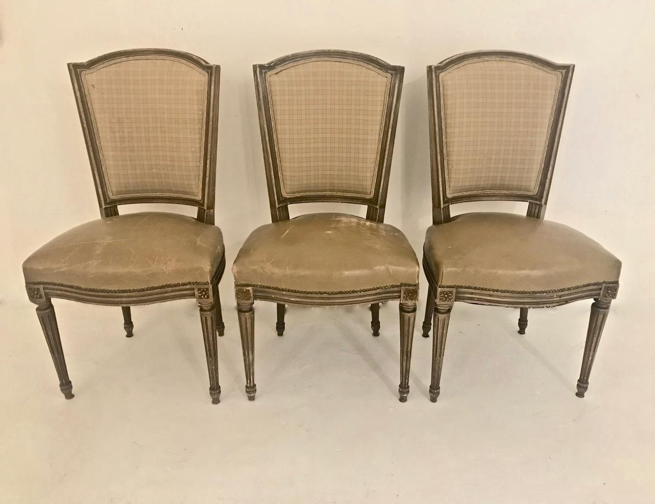 This is a highly decorative set of 6 French Louis XVI-style dining chairs that date to the first half of the twentieth century. The chairs retain their vintage caramel-colored French fabric backs that coordinate perfectly with the beautifully