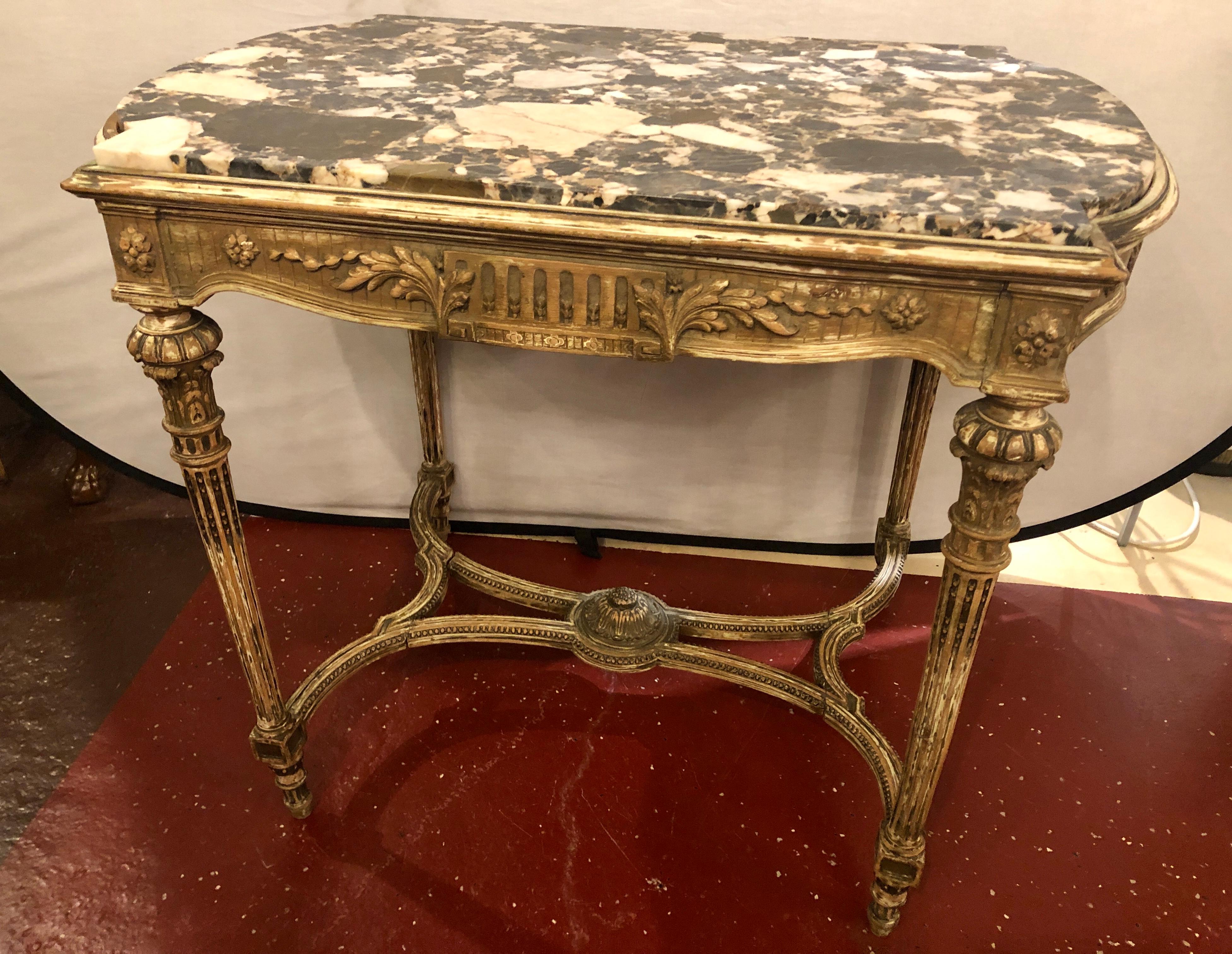 Louis XVI style distressed paint decorated 19th century marble top center table. This mid to late 19th century center table is simply spectacular. The carved undercarriage supporting a set of distressed reeded and carved legs leading to a finely