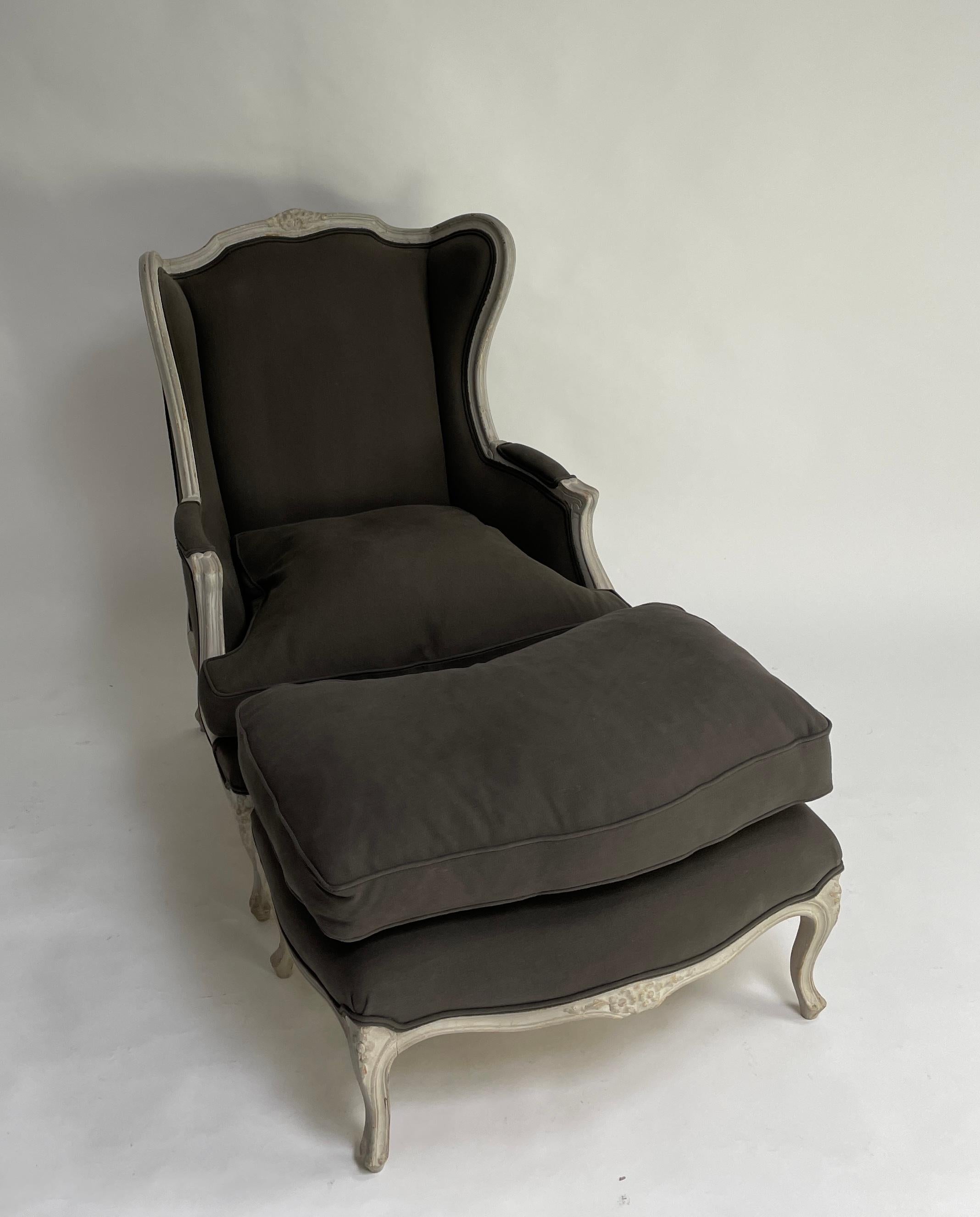 Gracious Louis XVI style arm chair with ottoman. New linen upholstery with down cushions.