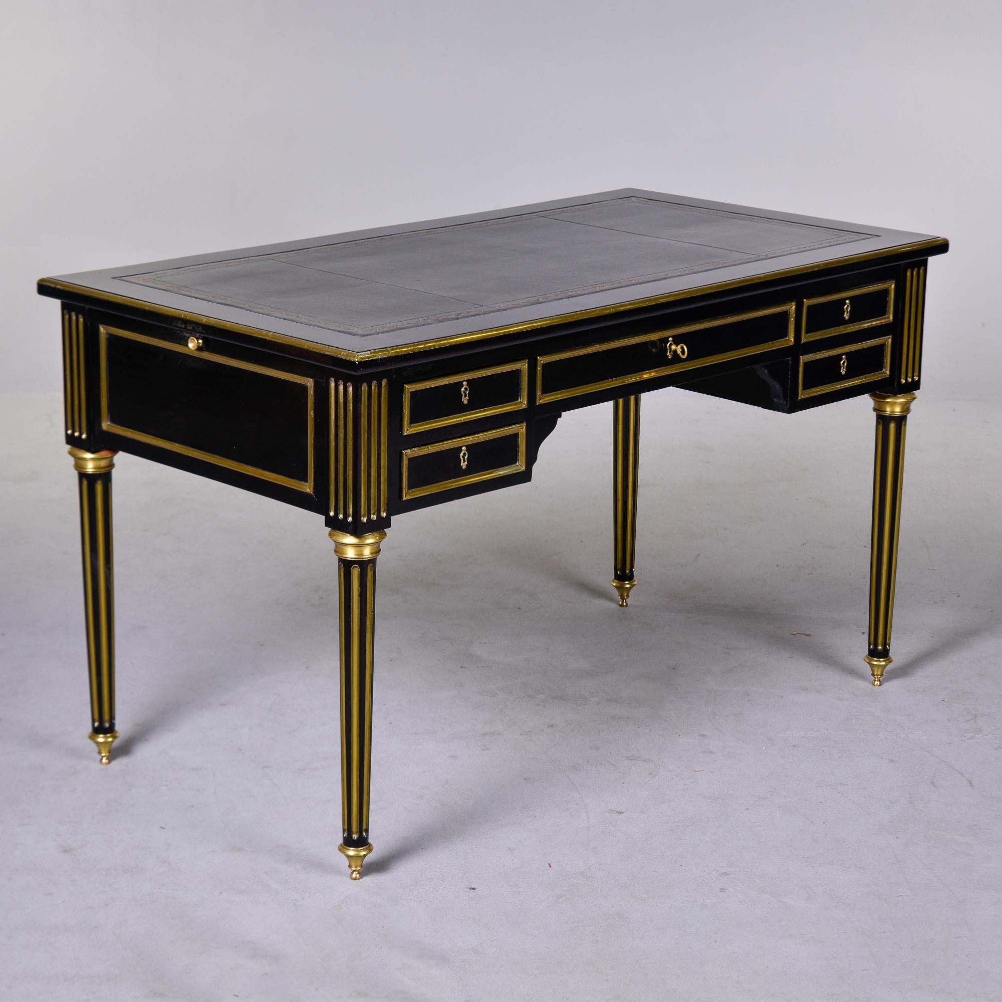 Found in France, this circa 1920s Louis XVI style desk has an ebonised finish and new black leather writing surface. The desk is finished on both front and back sides and can float in a room. Locking drawers with dovetail construction, brass