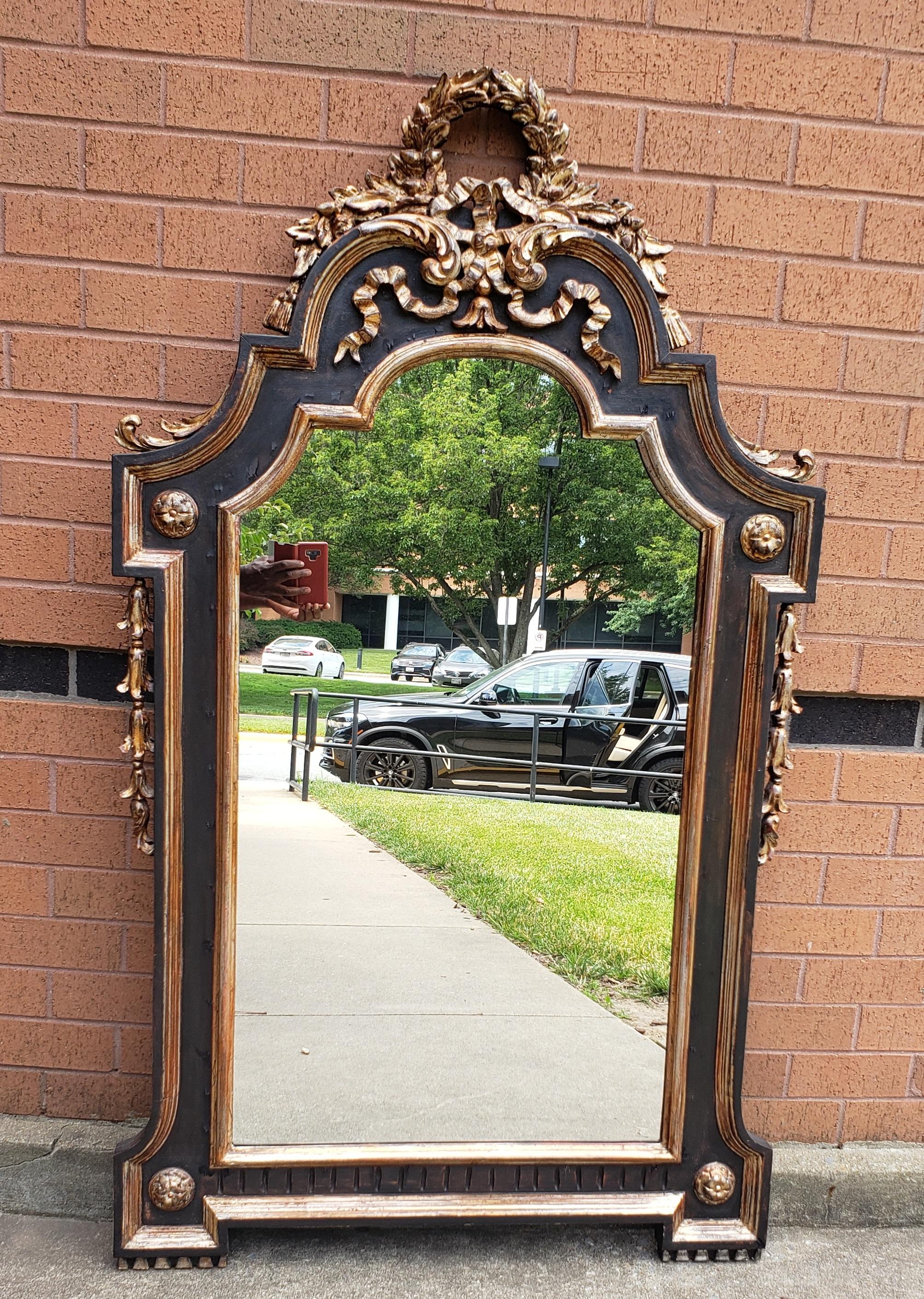 A large 62 inches Louis XVI style Ebonized and Gilt wood Gesso decorated wall mirror.
Measures 36.25