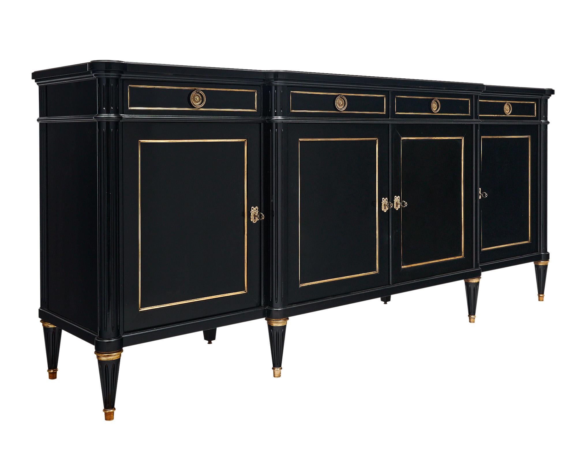 Buffet from France in the Louis XVI style. This solid mahogany sideboard has been ebonized and finished with a lustrous museum-quality polish. There are four dovetailed drawers above four doors that open to interior shelving. This piece is supported
