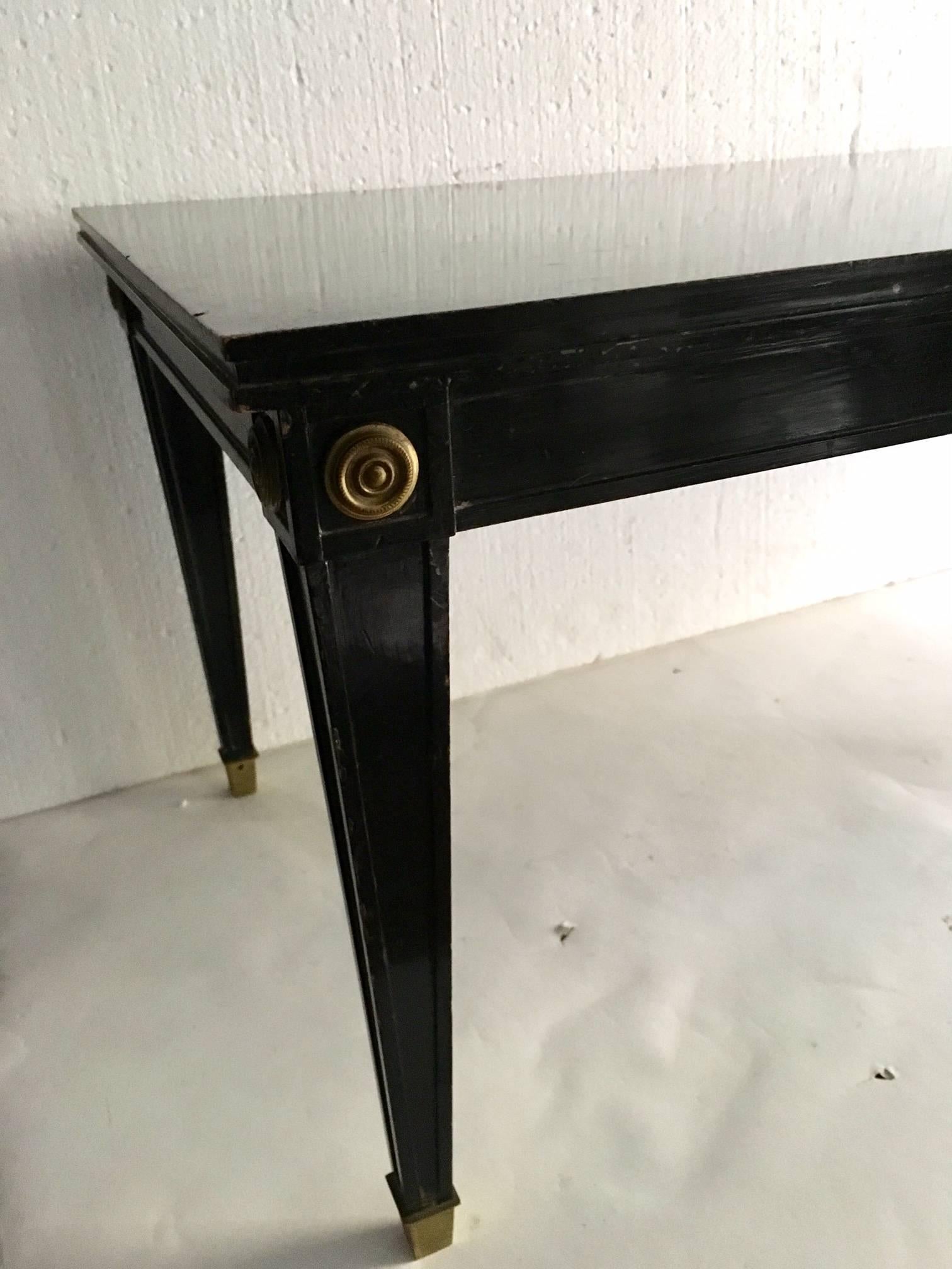 French, (Louis XVI style) ebonized and gilt trimmed coffee table with tapered square legs. 
   