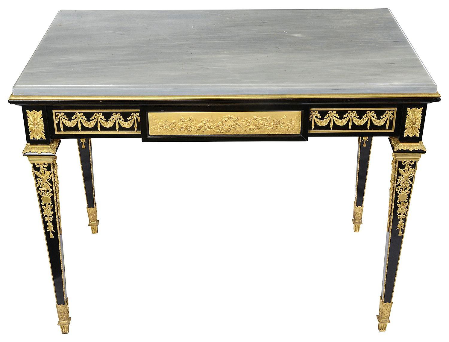 A fine quality late 19th Century Louis XVI style, Ebony, Marble topped, free standing centre table. Having wonderful gilded ormolu swag and scrolling foliate mounts, plaques depicting frolicking cherubs, Rams and masks. A single Oak lined frieze