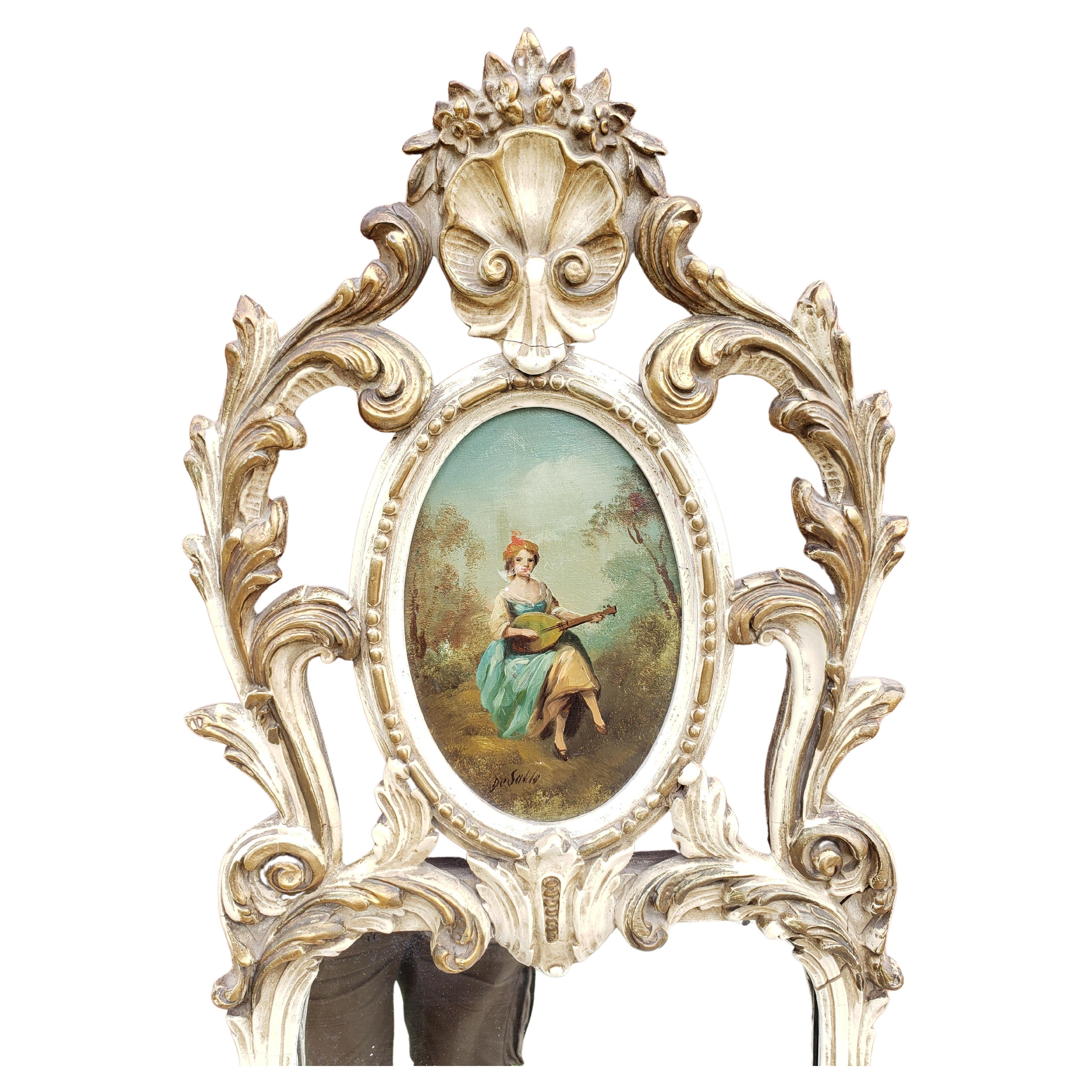 A 1930s impressive Louis XVI Style Enamel, Gilt Decorated and Hand Painted Trumeau mirror. 
Painting depicting a young lady playing a musical instrument. Signed Oil on canvas painting.