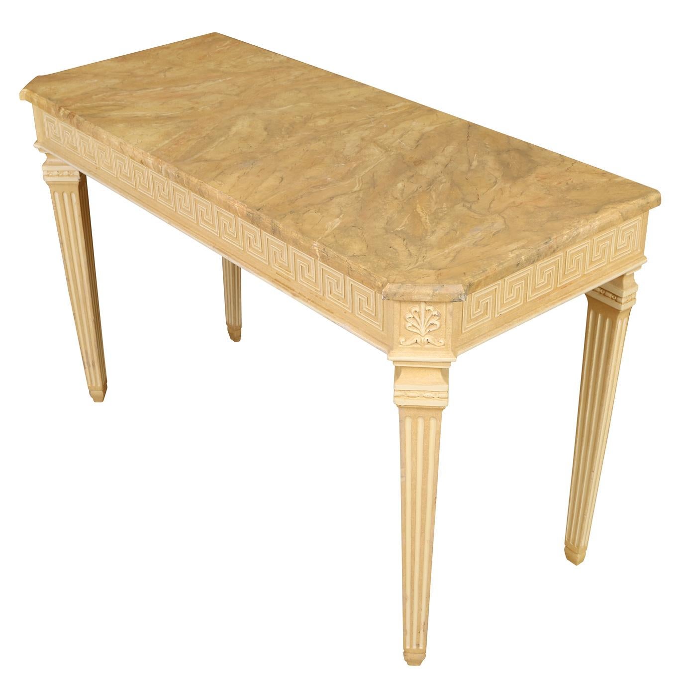 A Louis XVI style faux marble top painted console table with cream legs and base, and earth tones painted in cream, browns and taupe to the top. Greek key design carved to apron and legs are reeded with floral motif at top. Table and front legs are