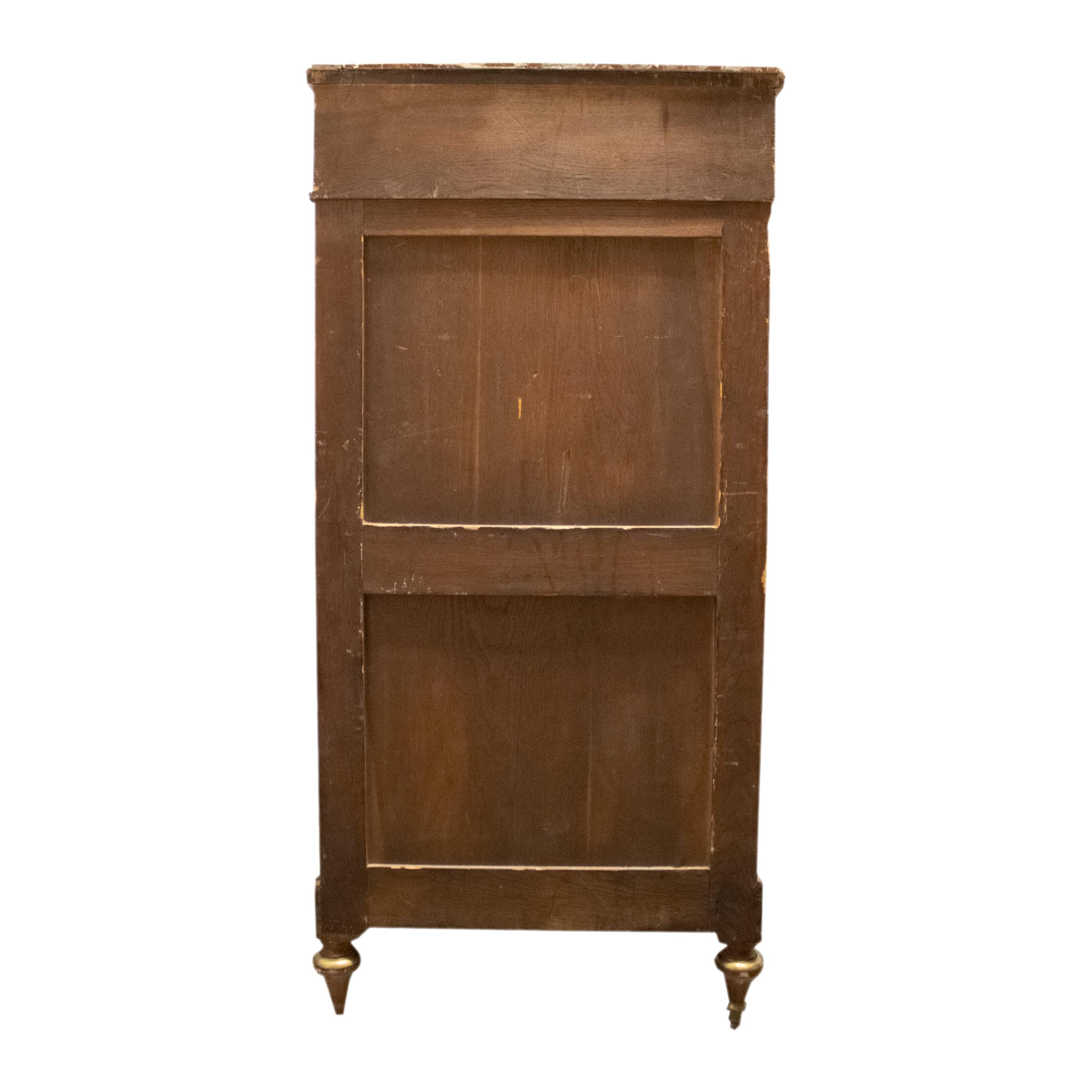 Cassettiera a quattro cassetti con coperchio a cerniera nascosto da cassetti trompe l'Oeil. È realizzato in mogano massiccio con maniglie e applicazioni in bronzo e un piano in marmo rosso francese. Stile Luigi XVI, epoca Napoleone III. Francia, XIX