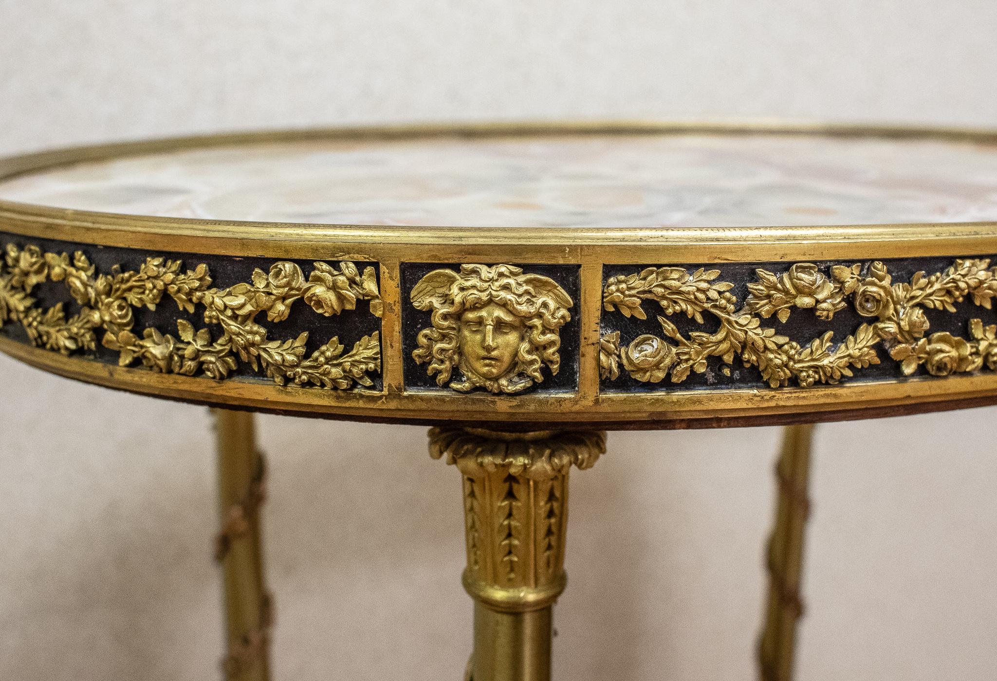 A very fine quality 19th century French Louis XVI style bronze doré marble top oval shape side table.
The bronze work on this table is of the finest quality almost like jewelry and the marble top is a very unusual onyx.