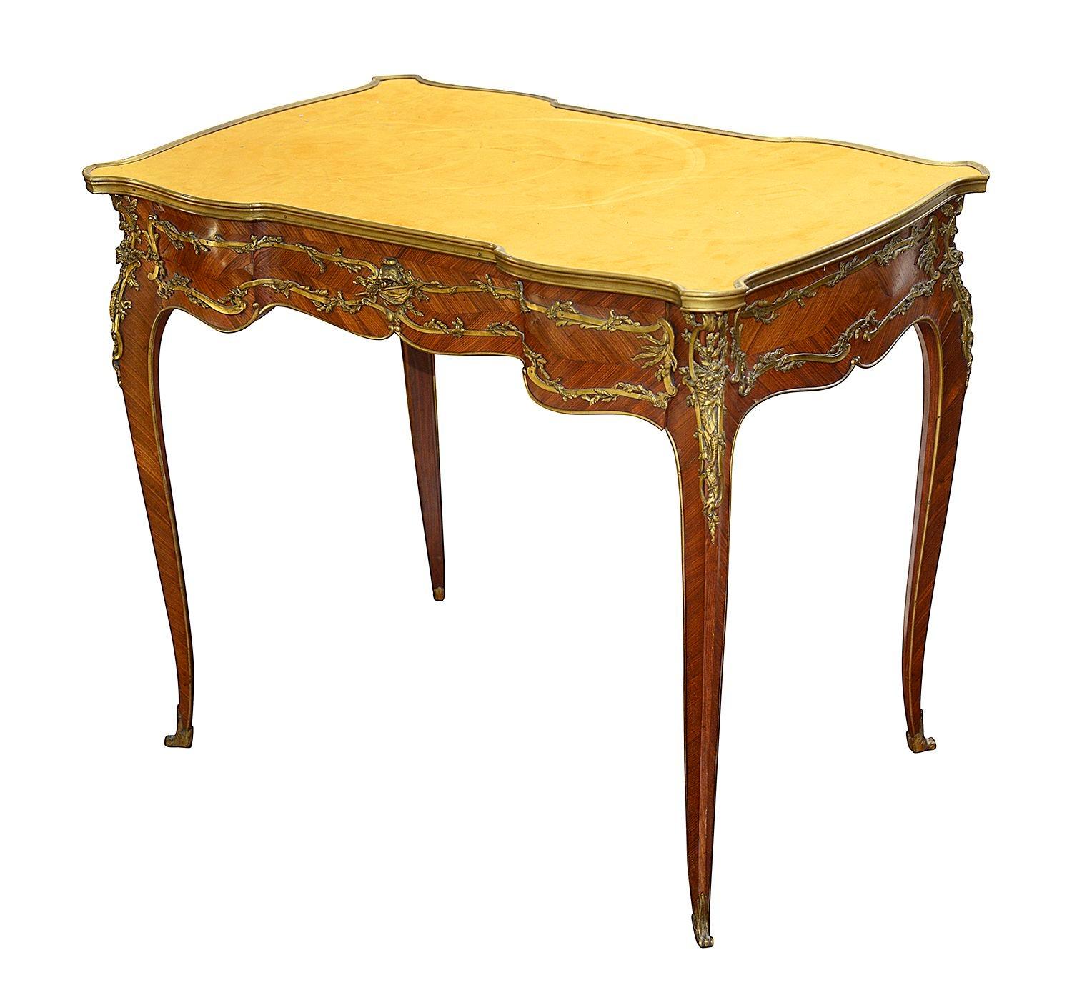 A fine quality, elegant late 19th century French Louis XV style Kingwood serpentine shaped bureau plat, having an inset suede covered writing surface, a single frieze drawer, wonderful gilded ormolu mounts with entwined leaf decoration, the central