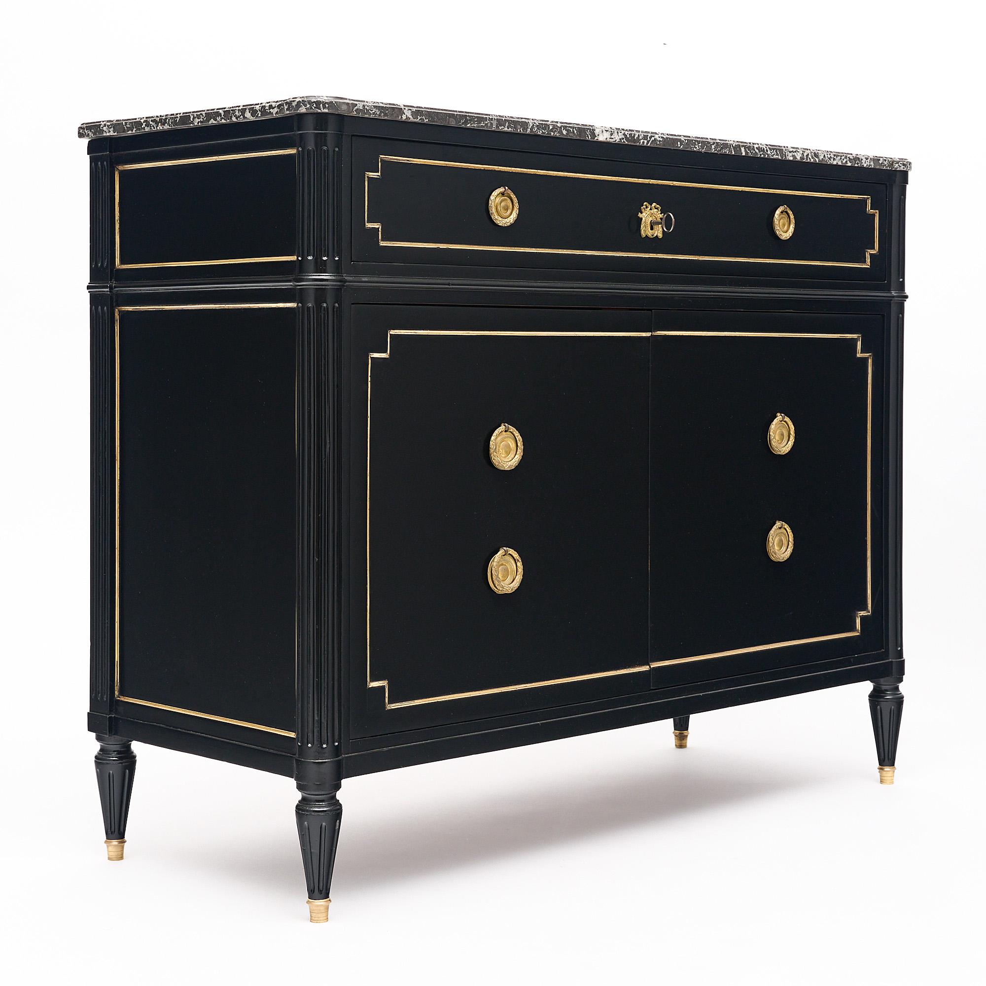 Scriban or secretary chest in the Louis XVI style from France. This piece is made of mahogany that has been ebonized and finished with a lustrous French polish. There are two doors that open to interior drawers. The top fake drawer drops down to
