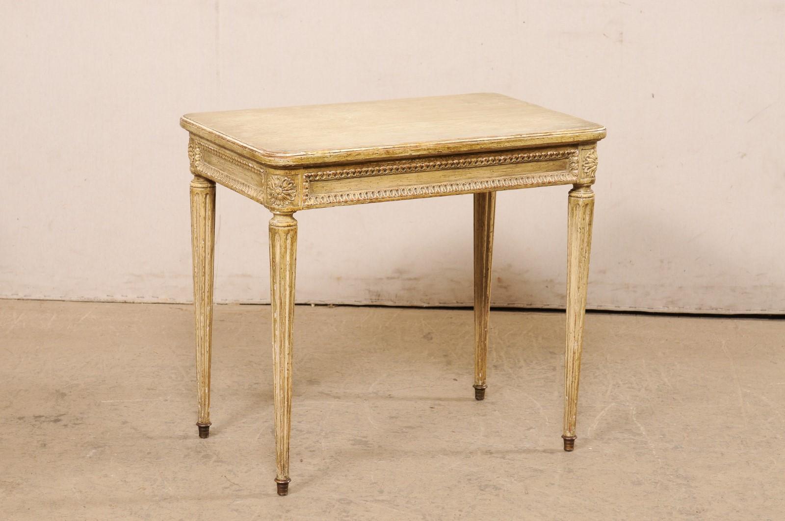 A French Louis XVI style side table with drawer, from the early 20th century. This antique rectangular-shaped table from France has been created in the Louis XVI style. The top has smoothly rounded corners and slightly overhangs the apron below