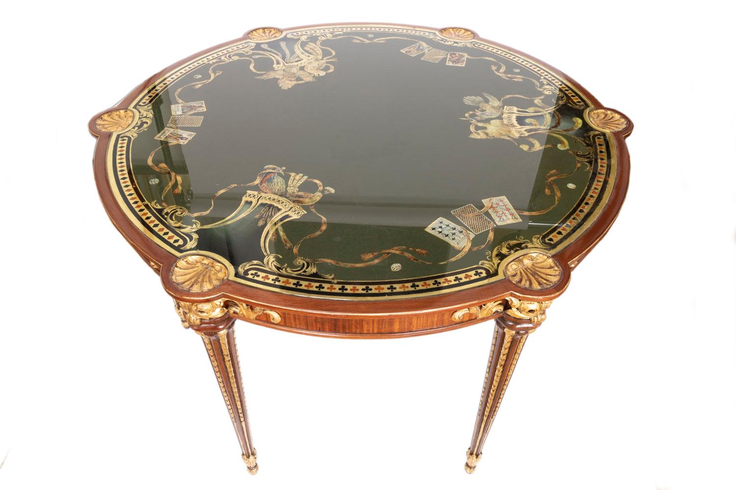 Pere Cosp i Villaro, stamped.

Circular Louis XVI style game table in veneered bloodwood, gilt highlights standing on four tapered, fluted legs with gilt chandelles and ending with carved and gilt acanthus leaves. Apron adorned beneathe every legs